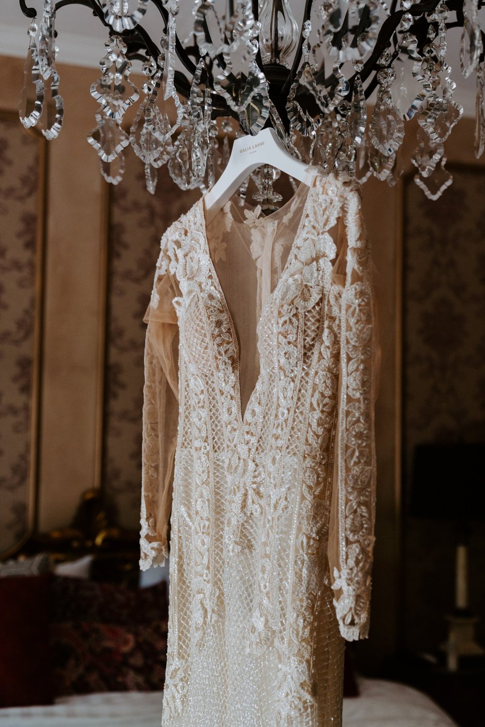 Galia Lahav bridal dress hanging from chandelier at  The Houdini Estate Wedding, Los Angeles Wedding Photography by Tida Svy