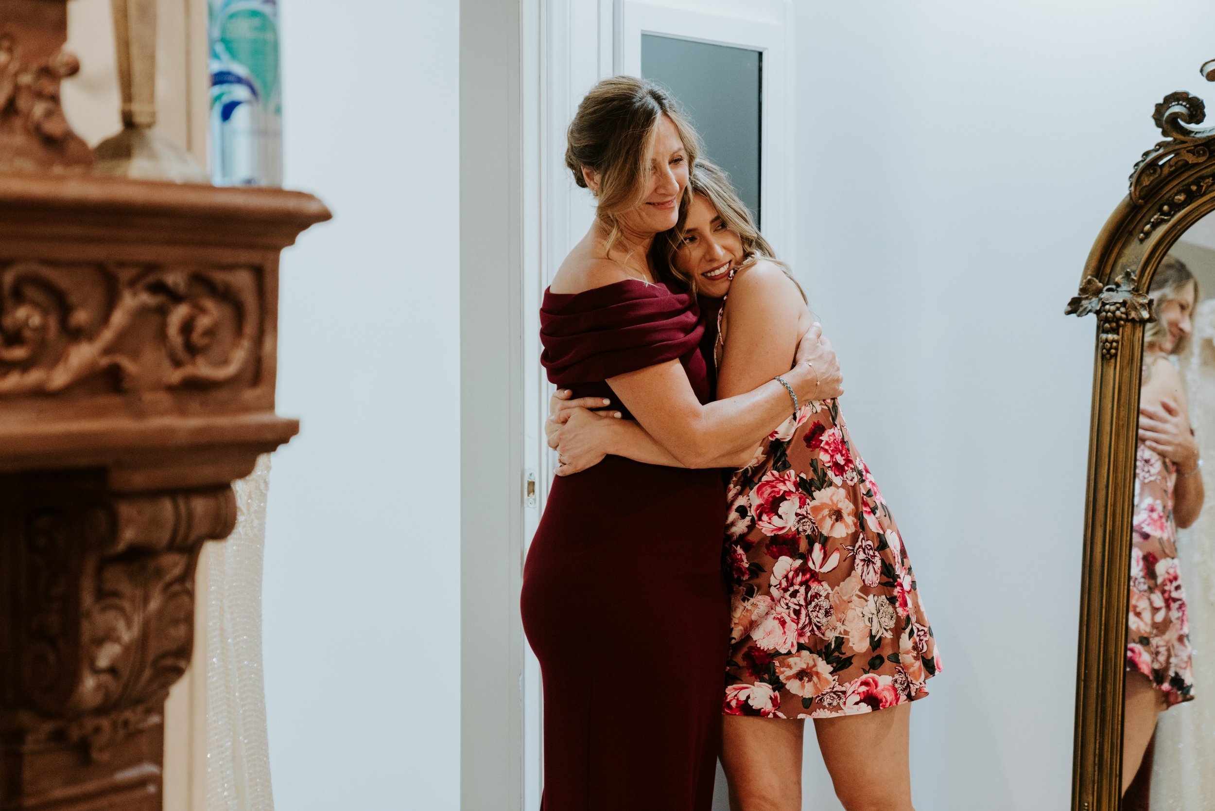 Candid photo of Bride and mother of the bride hugging while getting ready at The Houdini Estate Wedding, Los Angeles Wedding Photography by Tida Svy