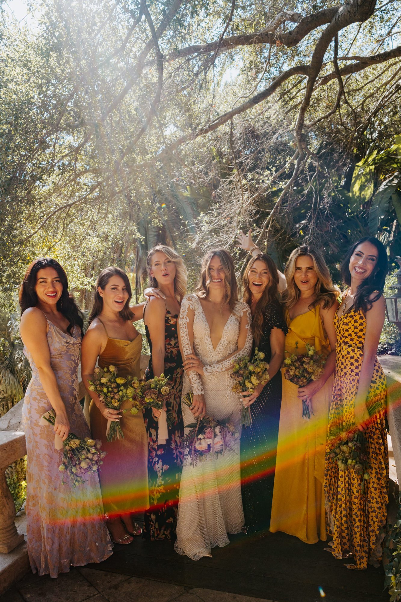 Unique and different bridesmaid dresses in a variety of gold mustard and purple at The Houdini Estate Wedding in Los Angeles, vibrant and candid wedding photographer Tida Svy