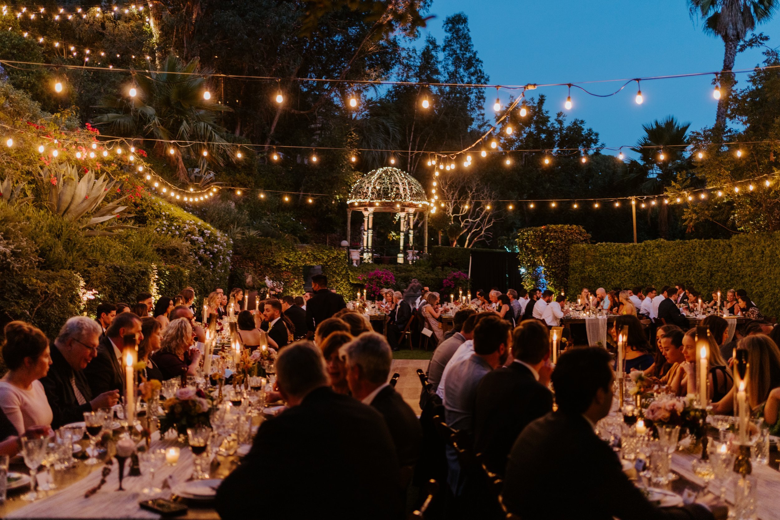 Romantic dimly lit wedding reception with string lights at The Houdini Estate wedding in los angeles, candid and vibrant wedding photography by Tida Svy
