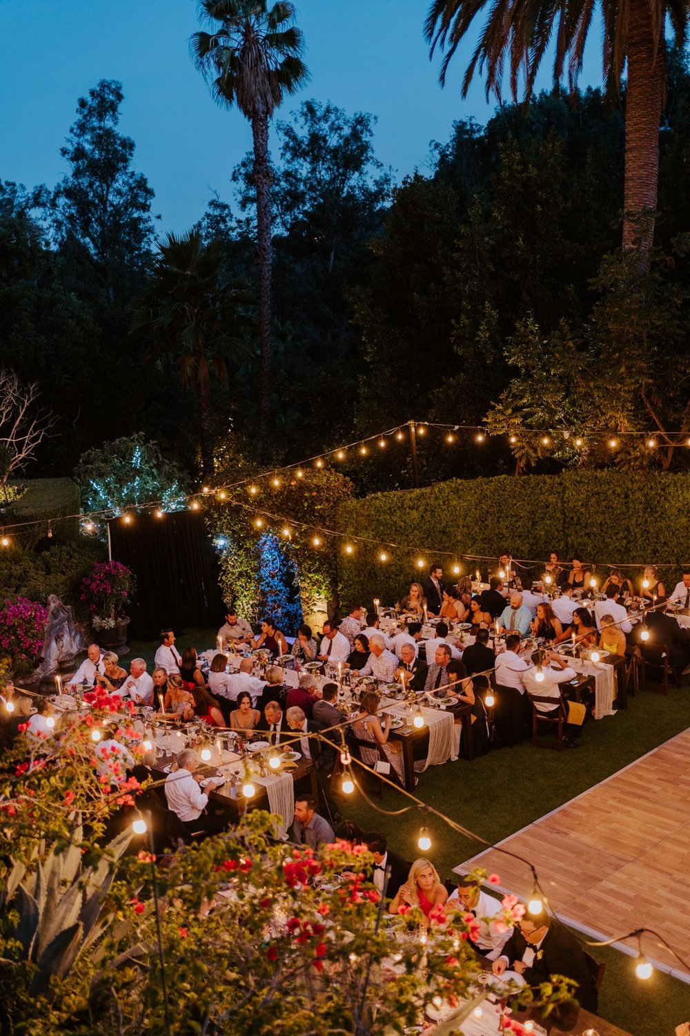 Romantic dimly lit wedding reception with string lights at The Houdini Estate wedding in los angeles, candid and vibrant wedding photography by Tida Svy