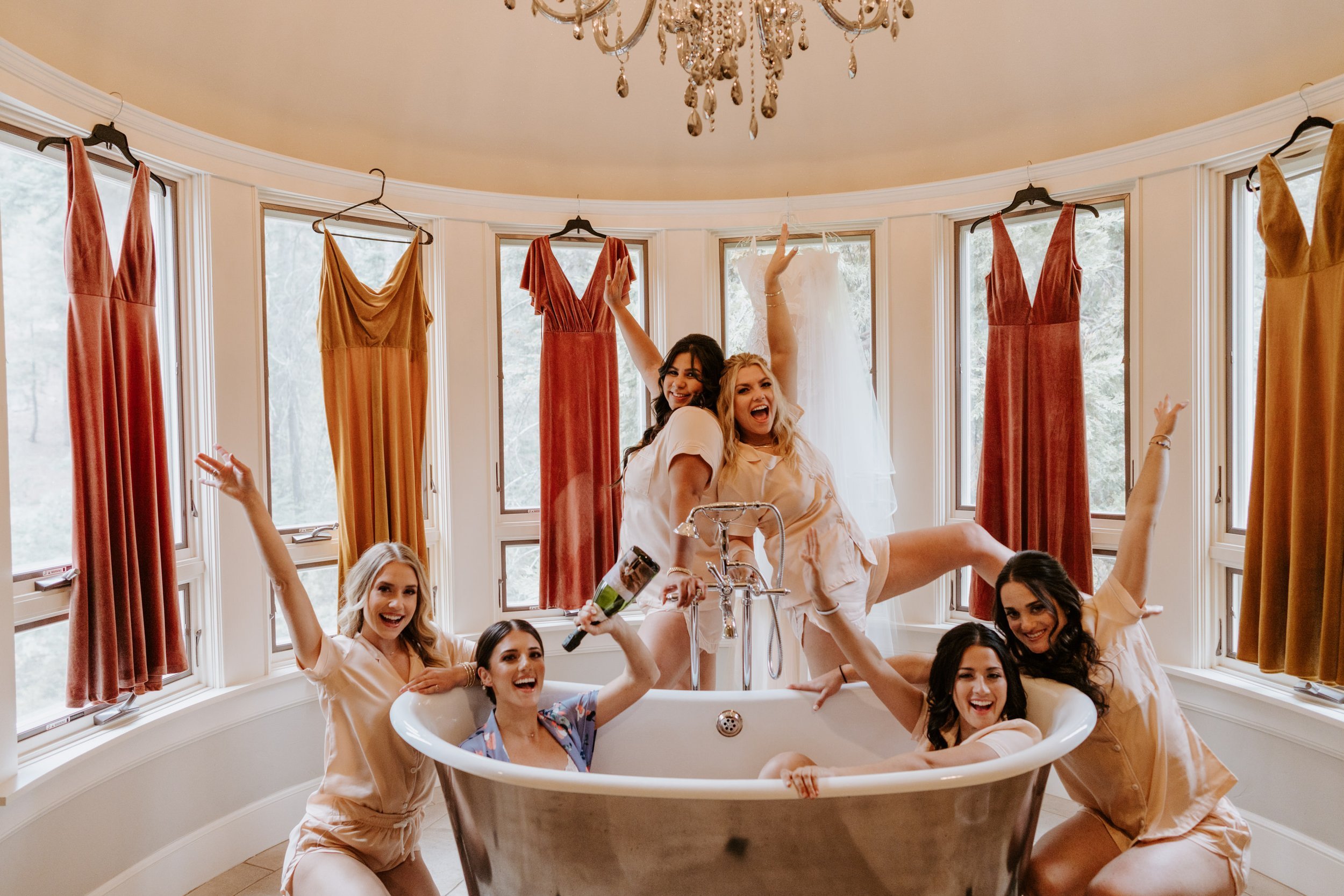 Neutral rose bridesmaid dresses, bride and bridesmaids getting ready at Castle in the Forest Lake Arrowhead wedding, large bathtub, photo by Tida Svy Photography
