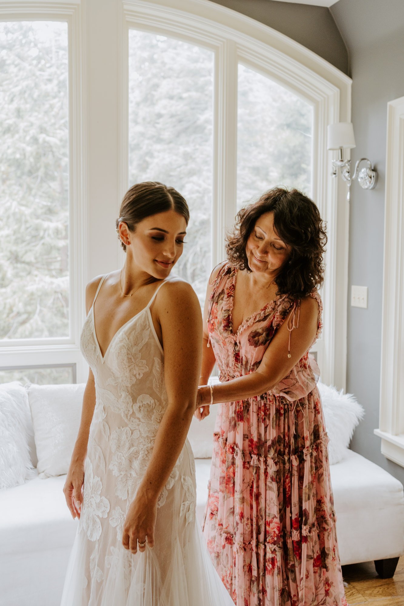 Bride and mother of the bride getting ready together in bridal suite, photo by Tida Svy Photography