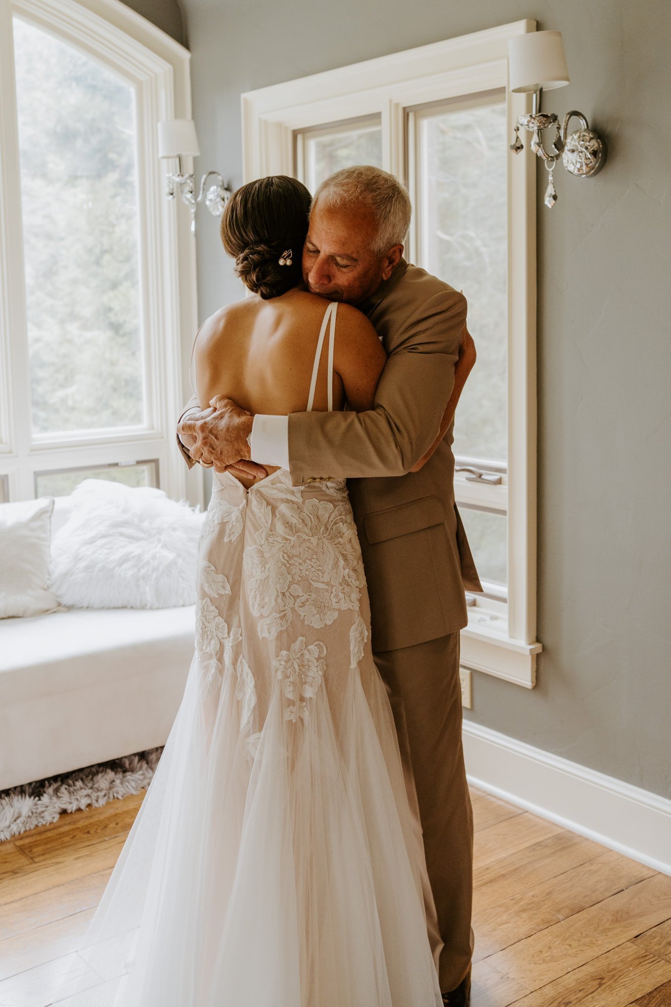 Emotional first look with father of the bride and bride hugging, getting ready at Castle in the Forest wedding, photo by Tida Svy Photography