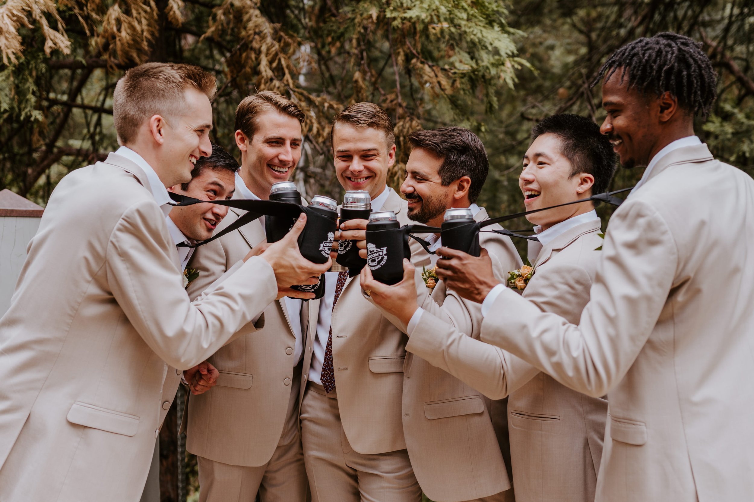 Fun groomsmen beer cozie ties getting ready at Castle in the Forest Wedding in Lake Arrowhead, Photo by Tida Svy