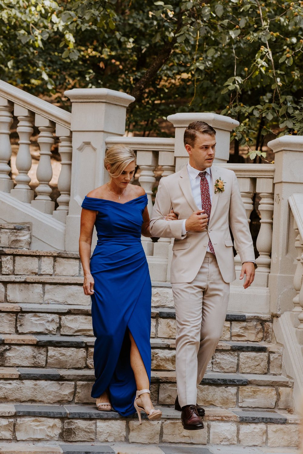 Groom walking mother of the groom down the stairs, Castle in the Forest Lake Arrowhead Wedding Ceremony Set Up,  Photo by Tida Svy