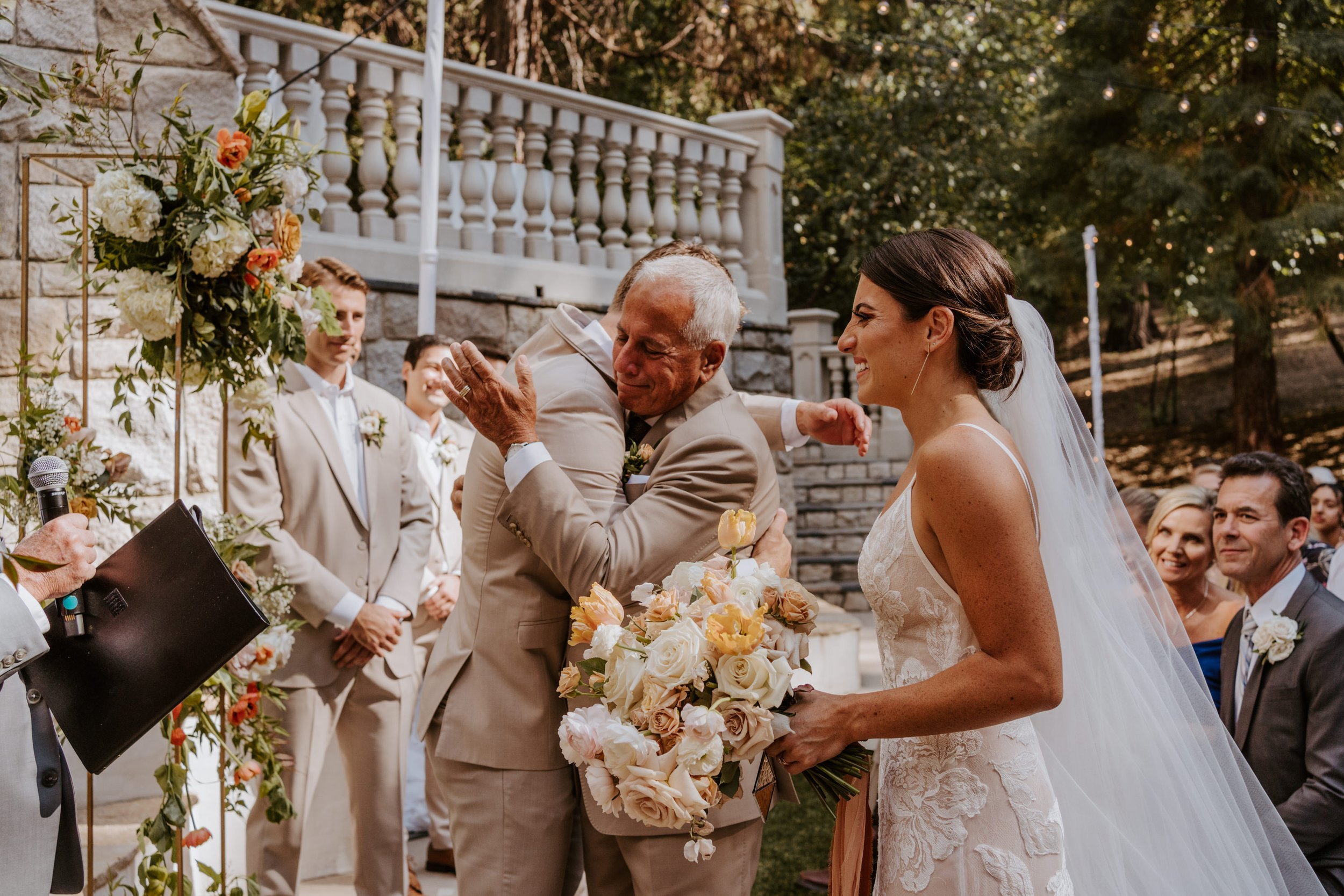 Bride and father of the bride emotional hug at the aisle, Castle in the Forest Lake Arrowhead Wedding Ceremony,  Photo by Tida Svy