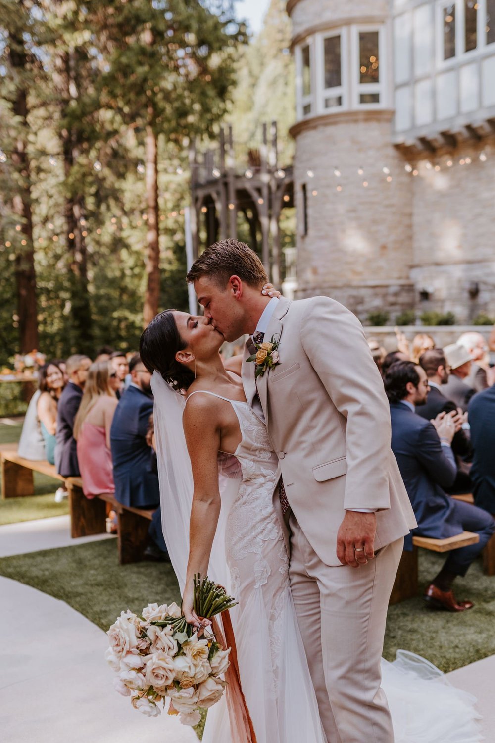Bride and Groom kissing at the end of the aisle, Castle in the Forest Lake Arrowhead Wedding Ceremony,  Photo by Tida Svy