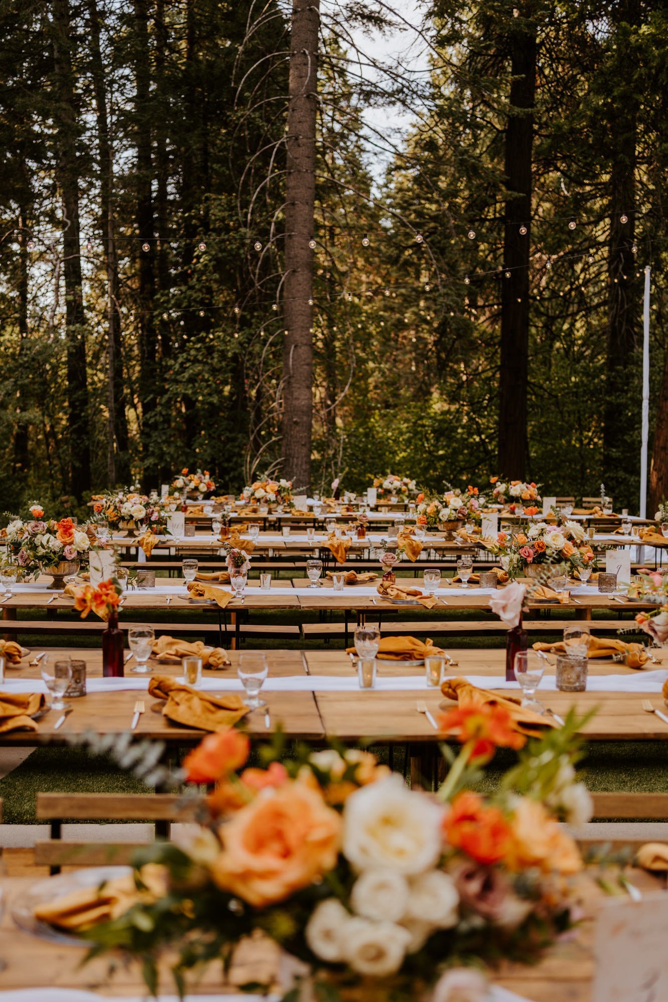 Enchanted forest castle wedding at Castle in the Forest in Lake Arrowhead, magical castle airbnb wedding, orange pink and beige wedding centerpiece, long tables, photography by Tida Svy