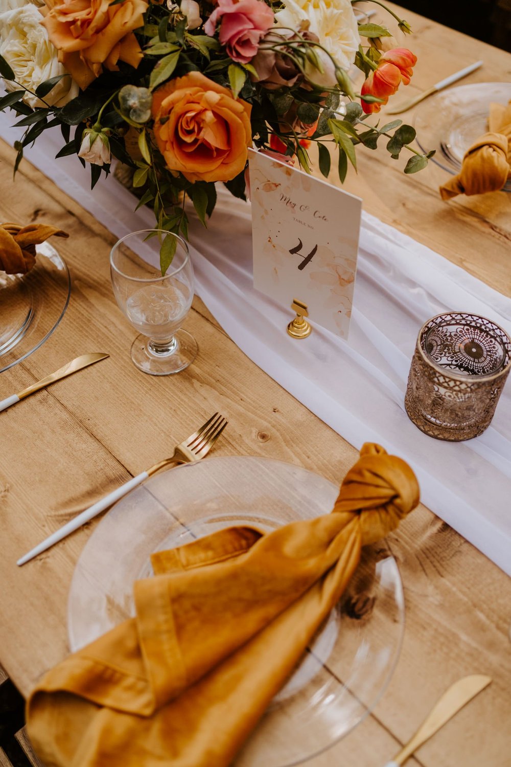 Enchanted forest castle wedding at Castle in the Forest in Lake Arrowhead, magical castle airbnb wedding, orange pink and beige wedding centerpiece, long tables, photography by Tida Svy