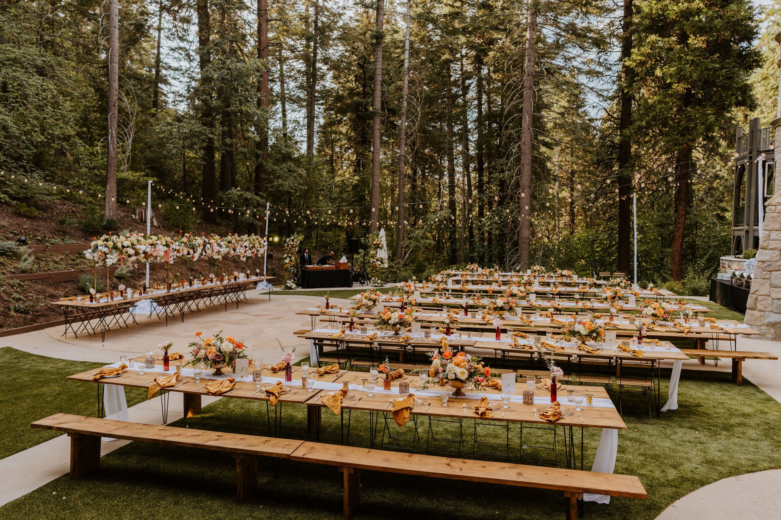 Enchanted forest castle wedding at Castle in the Forest in Lake Arrowhead, magical castle airbnb wedding, orange pink and beige wedding reception tables, long tables, photography by Tida Svy