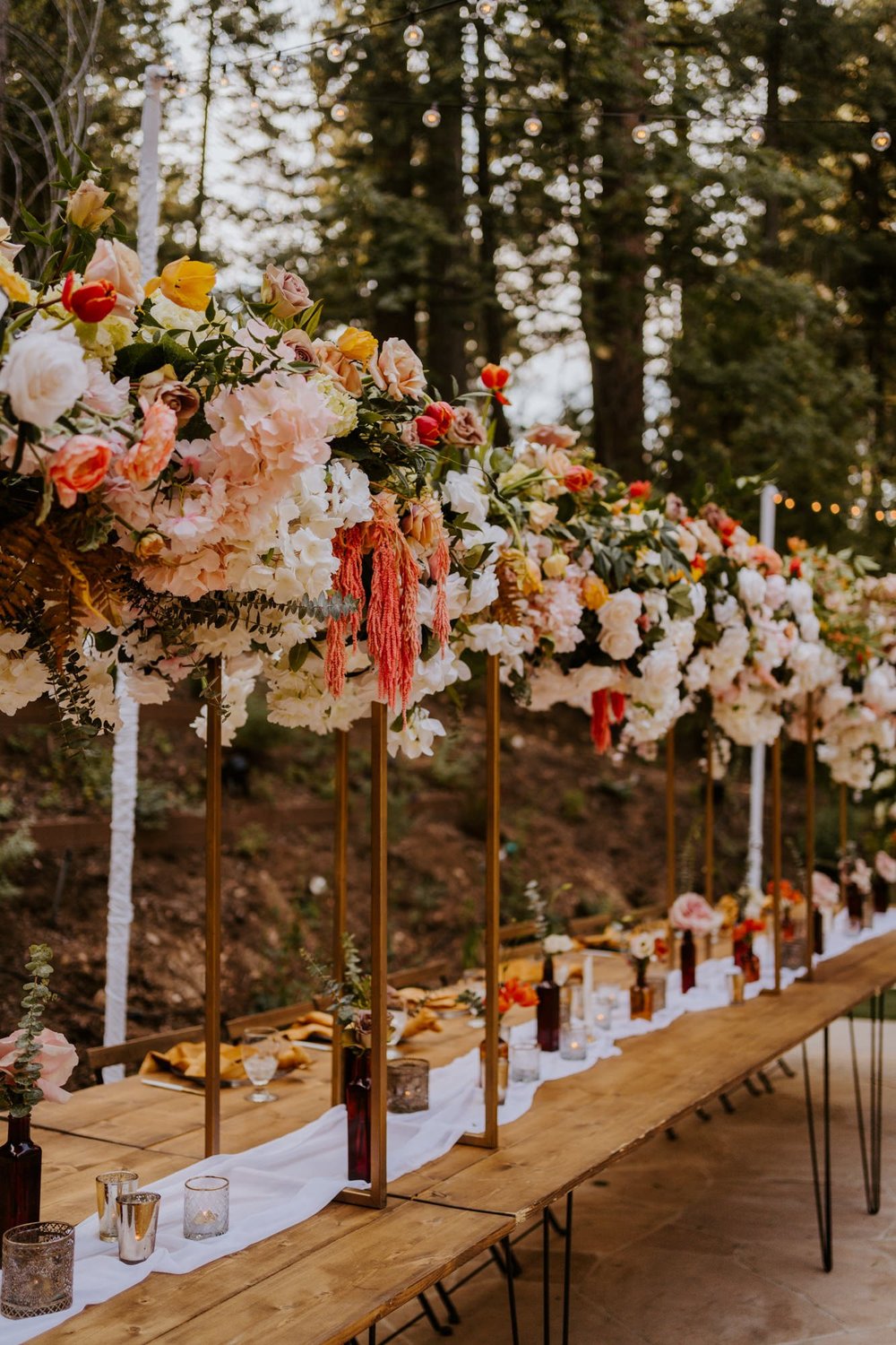 Enchanted forest castle wedding at Castle in the Forest in Lake Arrowhead, magical castle airbnb wedding, long bridal party head table, floating cloud floral centerpiece, photography by Tida Svy