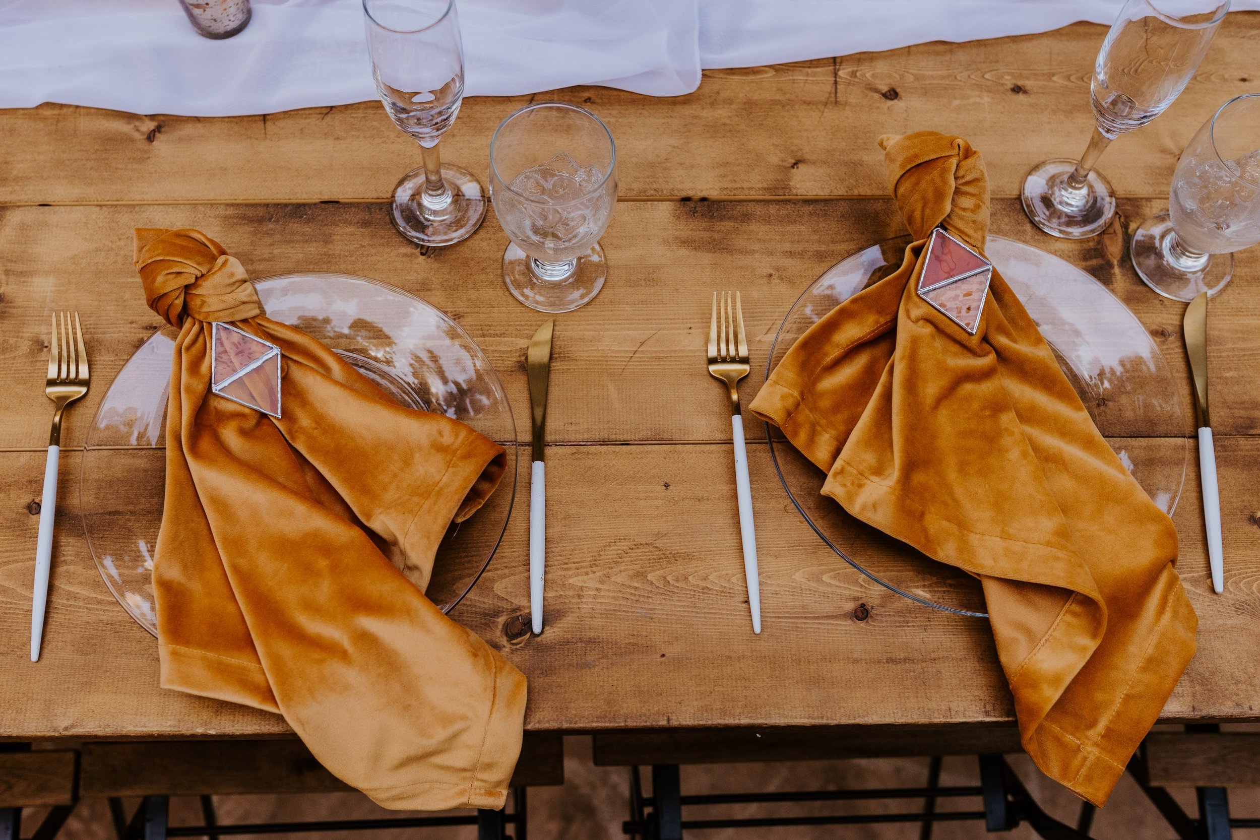 Enchanted forest castle wedding at Castle in the Forest in Lake Arrowhead, magical castle airbnb wedding, mustard velvet napkins with stained glass napkin rings, photography by Tida Svy