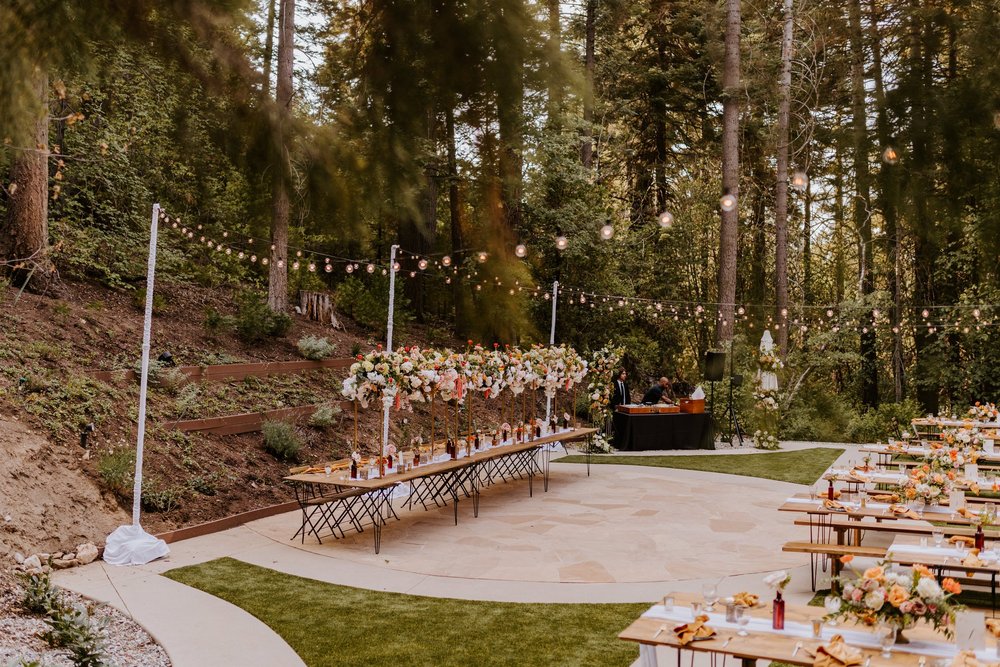 Enchanted forest castle wedding at Castle in the Forest in Lake Arrowhead, magical castle airbnb wedding, long bridal party head table, floating cloud floral centerpiece, photography by Tida Svy