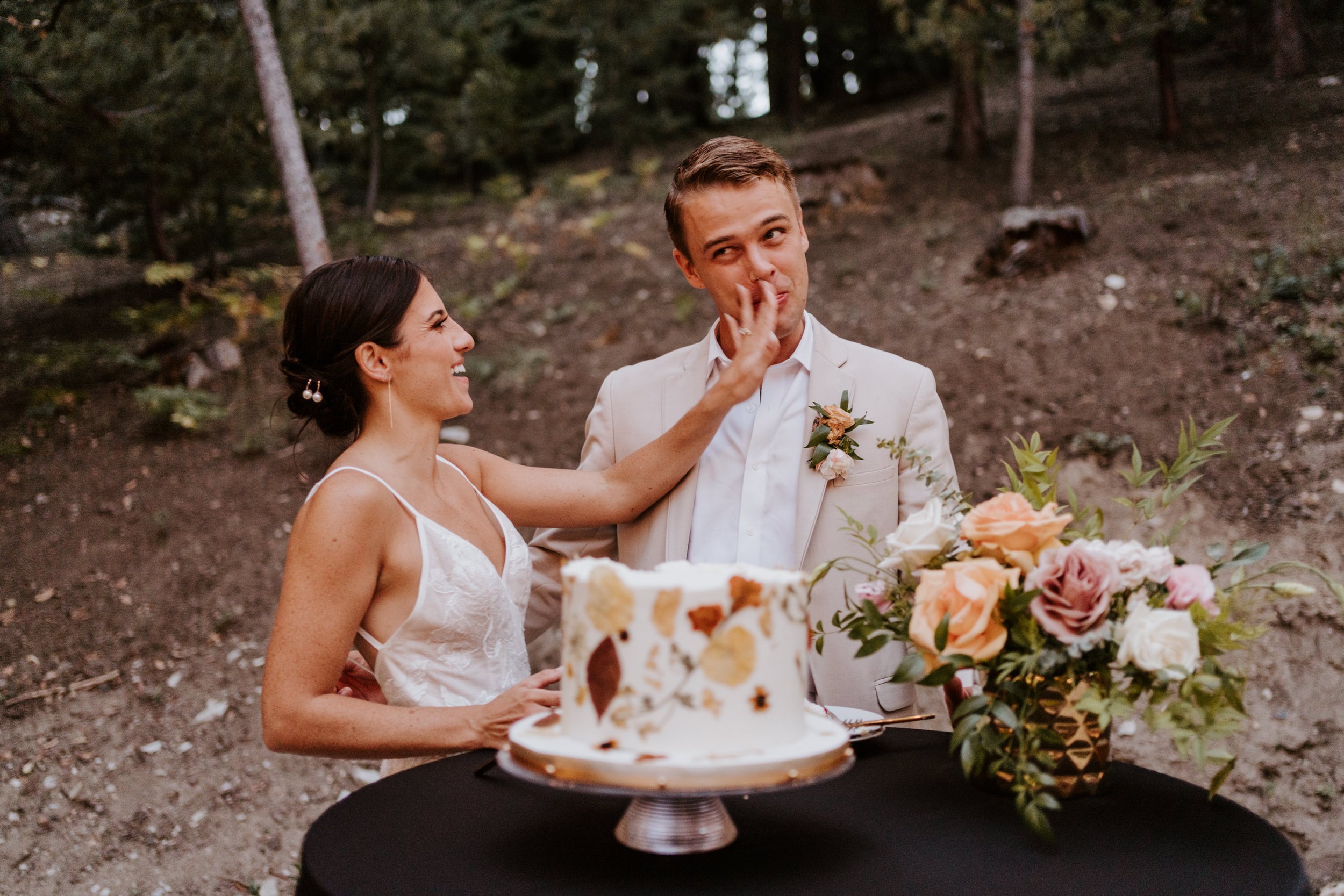 Fun cake cutting photo, Simple enchanted whimsical fall wedding cake, Castle in the Forest Lake Arrowhead airbnb wedding, Photo by Tida Svy