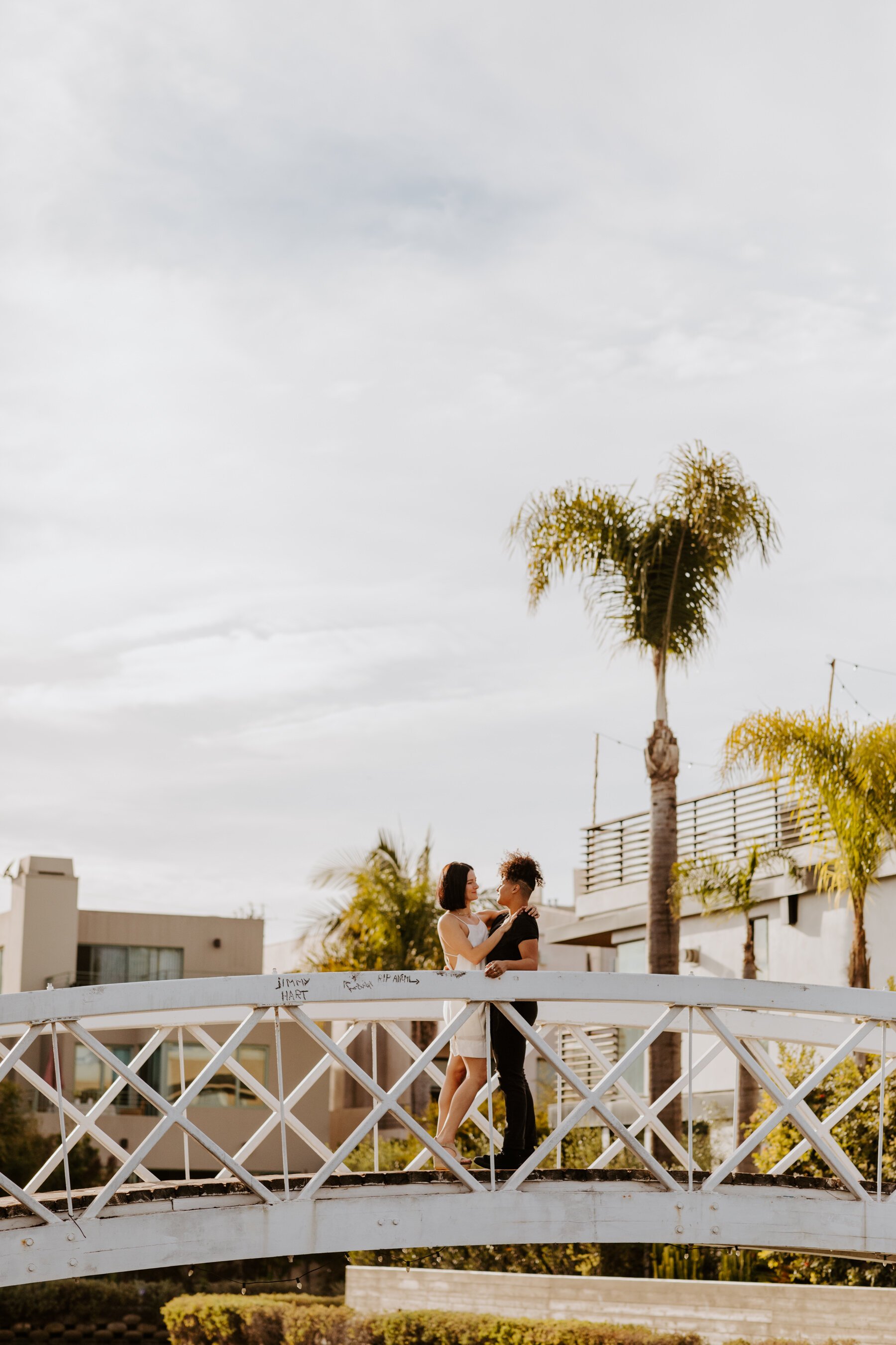 Venice Canals engagement session with lesbian couple on bridge, photography by LGTBQ friendly photographer Tida Svy
