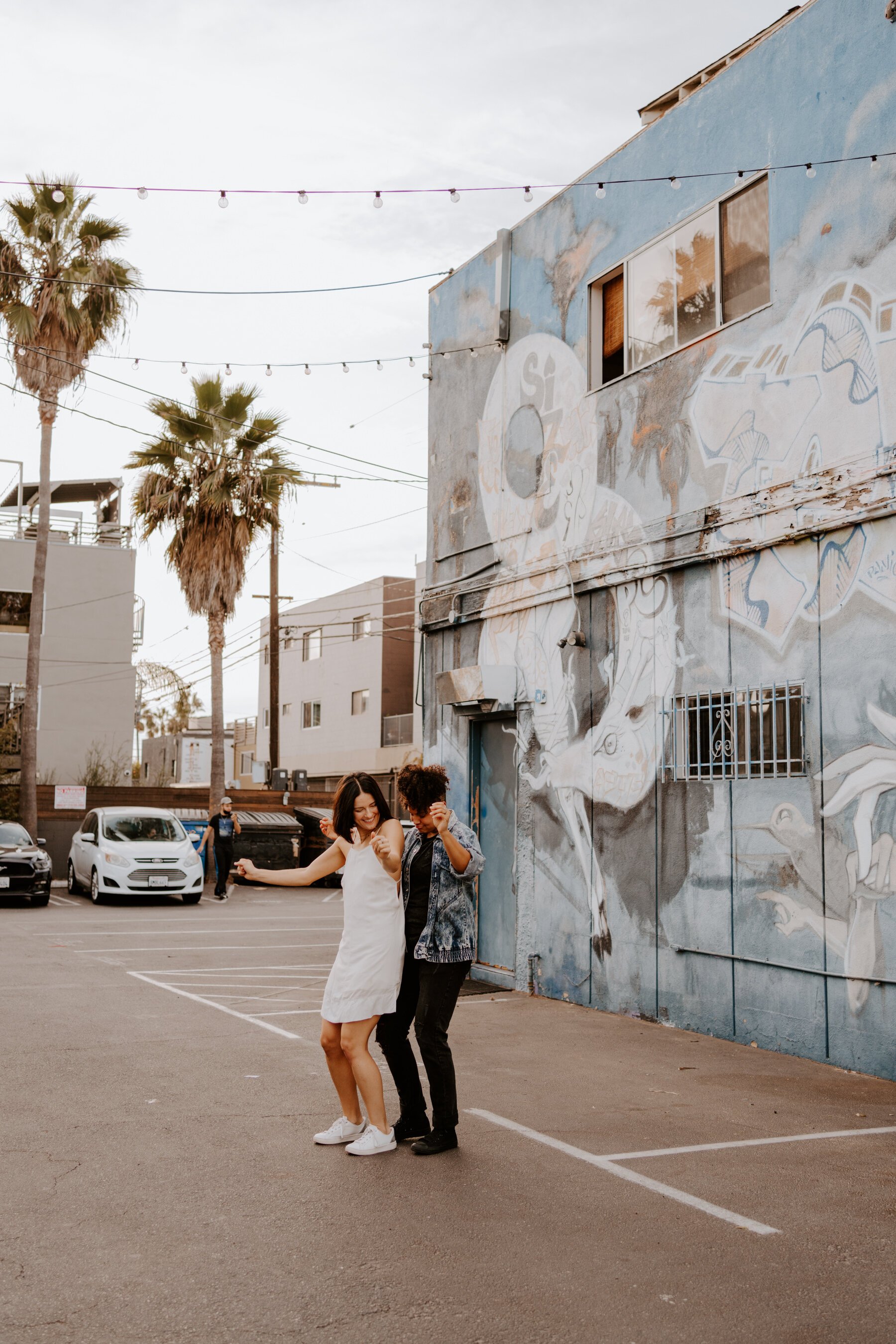 Lesbian couple dancing at their Venice Beach engagement session near Los Angeles, CA, Photography by Tida Svy LGBTQ friendly photographer