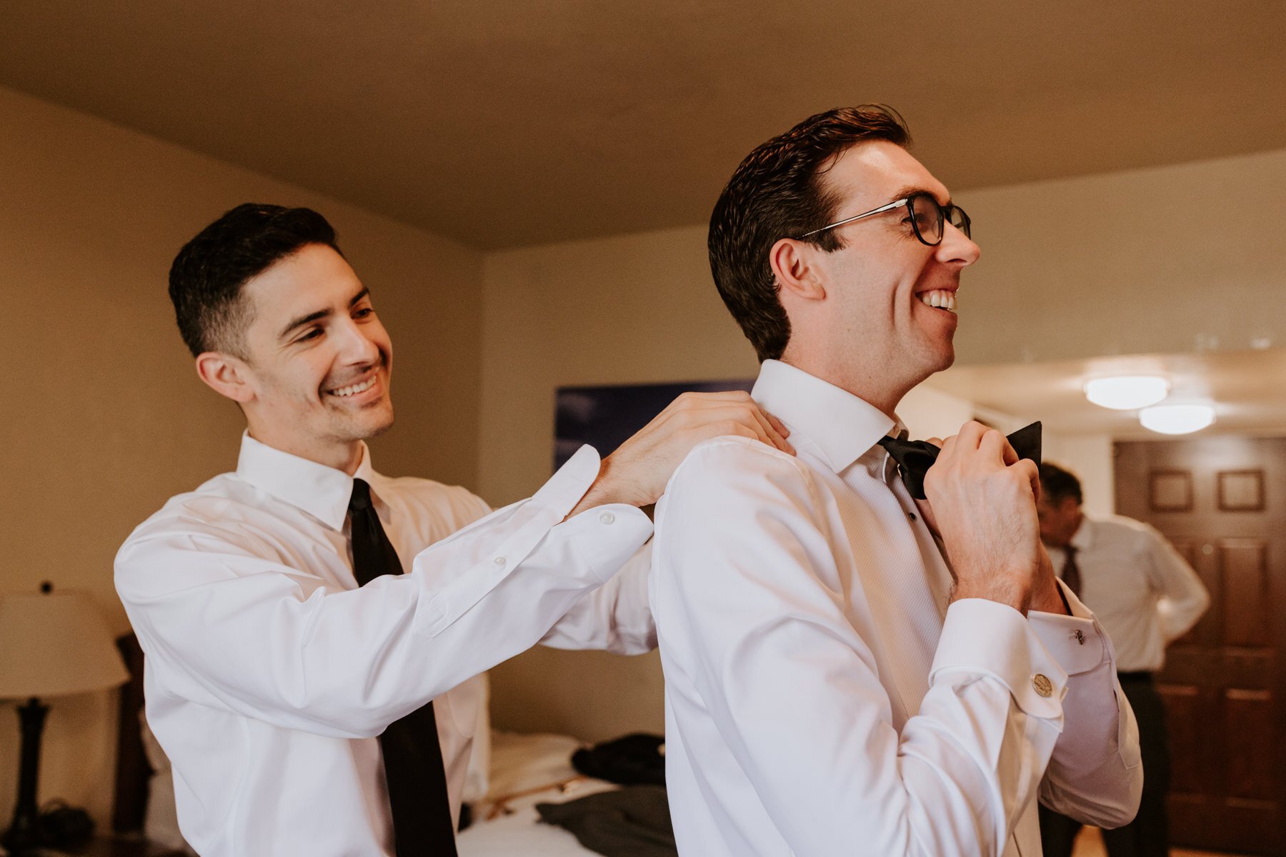  Best man tying bow tie on Groom getting ready, Palm Springs Wedding Photographer | Palm Mountain Resort and Spa | Tida Svy Photography 