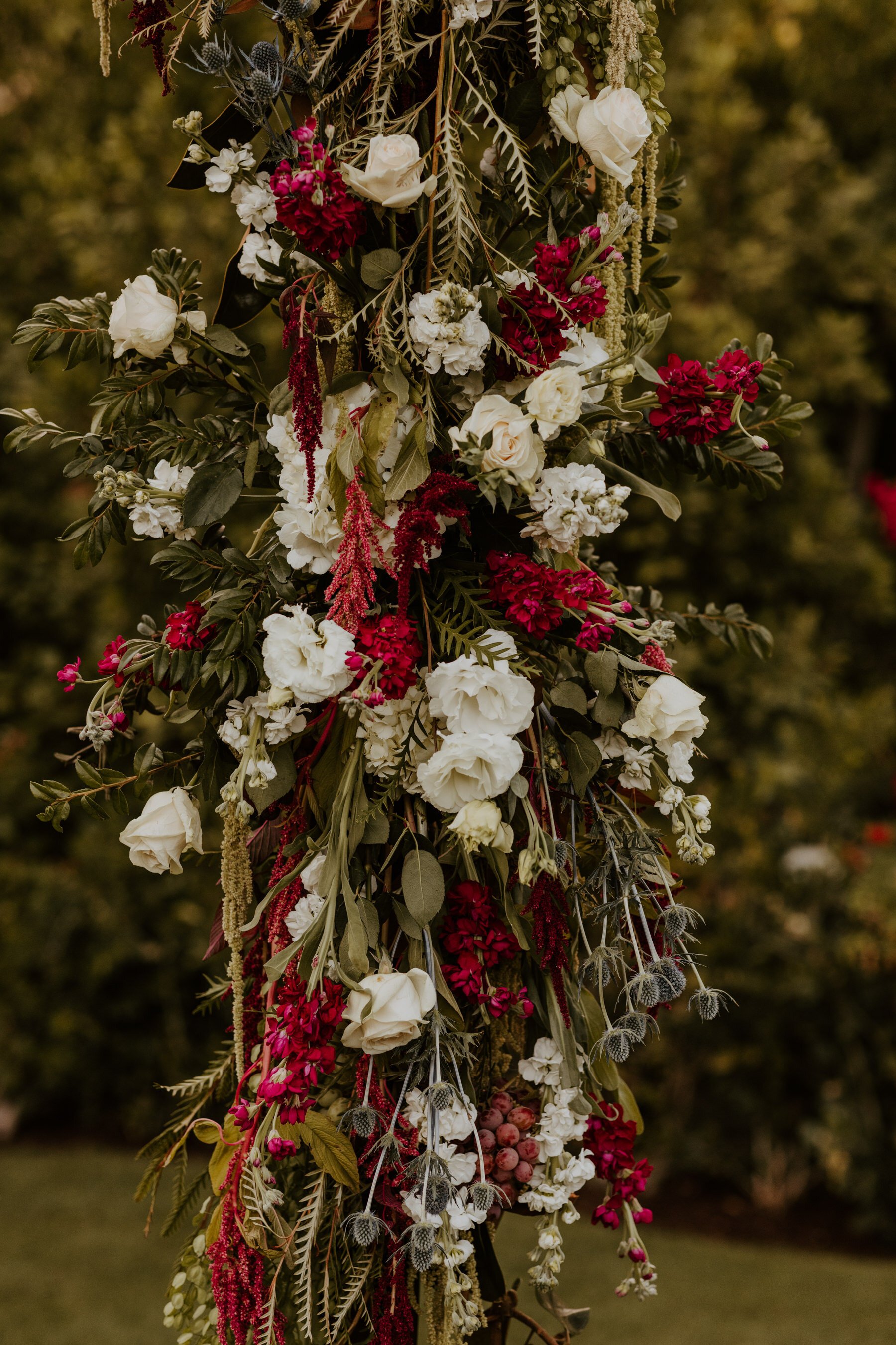 Jewel Toned Burgundy White and Green cascading flowers on rectangle wedding arch, Palm Springs Wedding, Spencer’s Restaurant Palm Springs Wedding, Tida Svy Photo