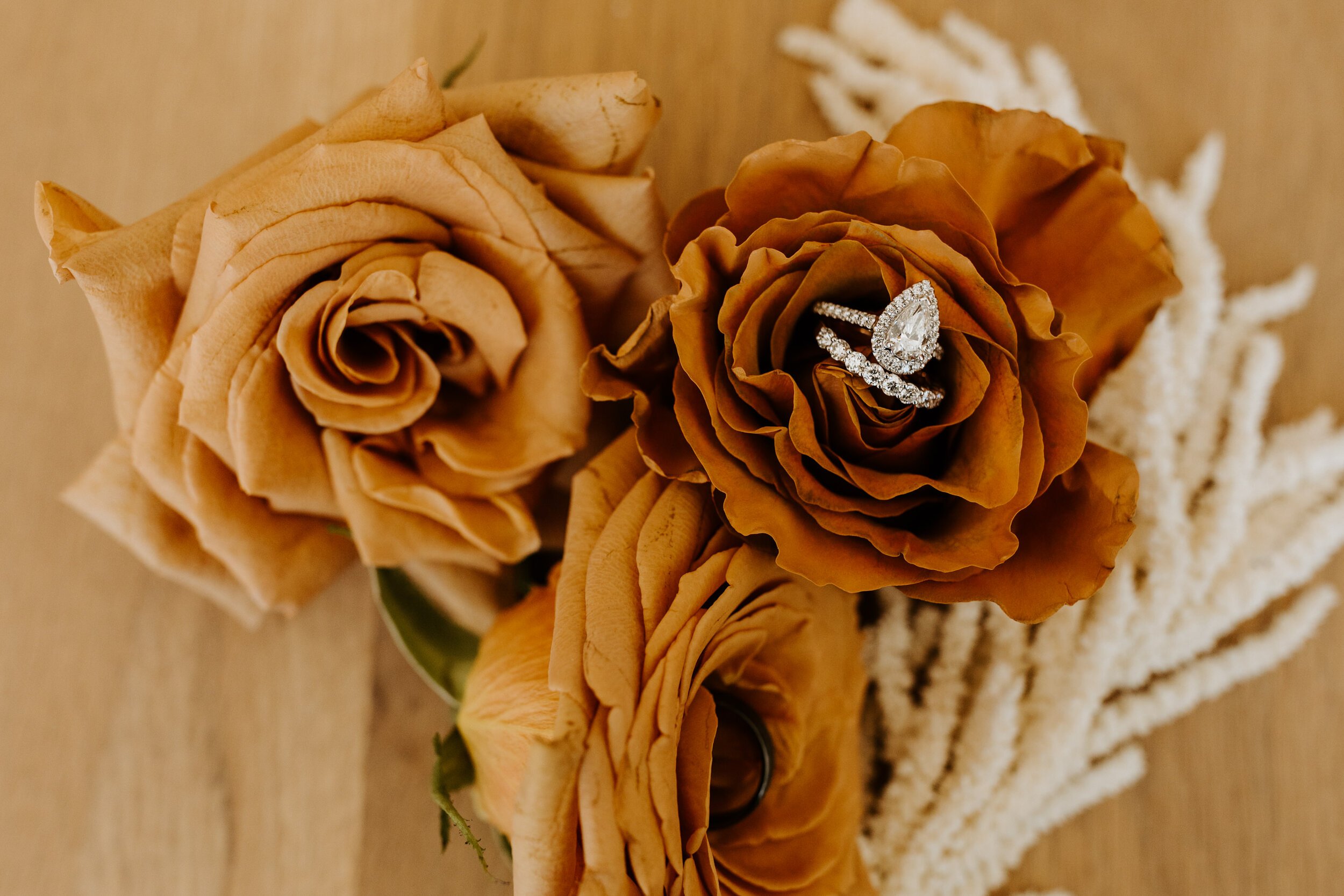 Neutral rust flowers and ring detail photo | Joshua Tree Elopement | Tida Svy Photo | www.tidasvy.com 