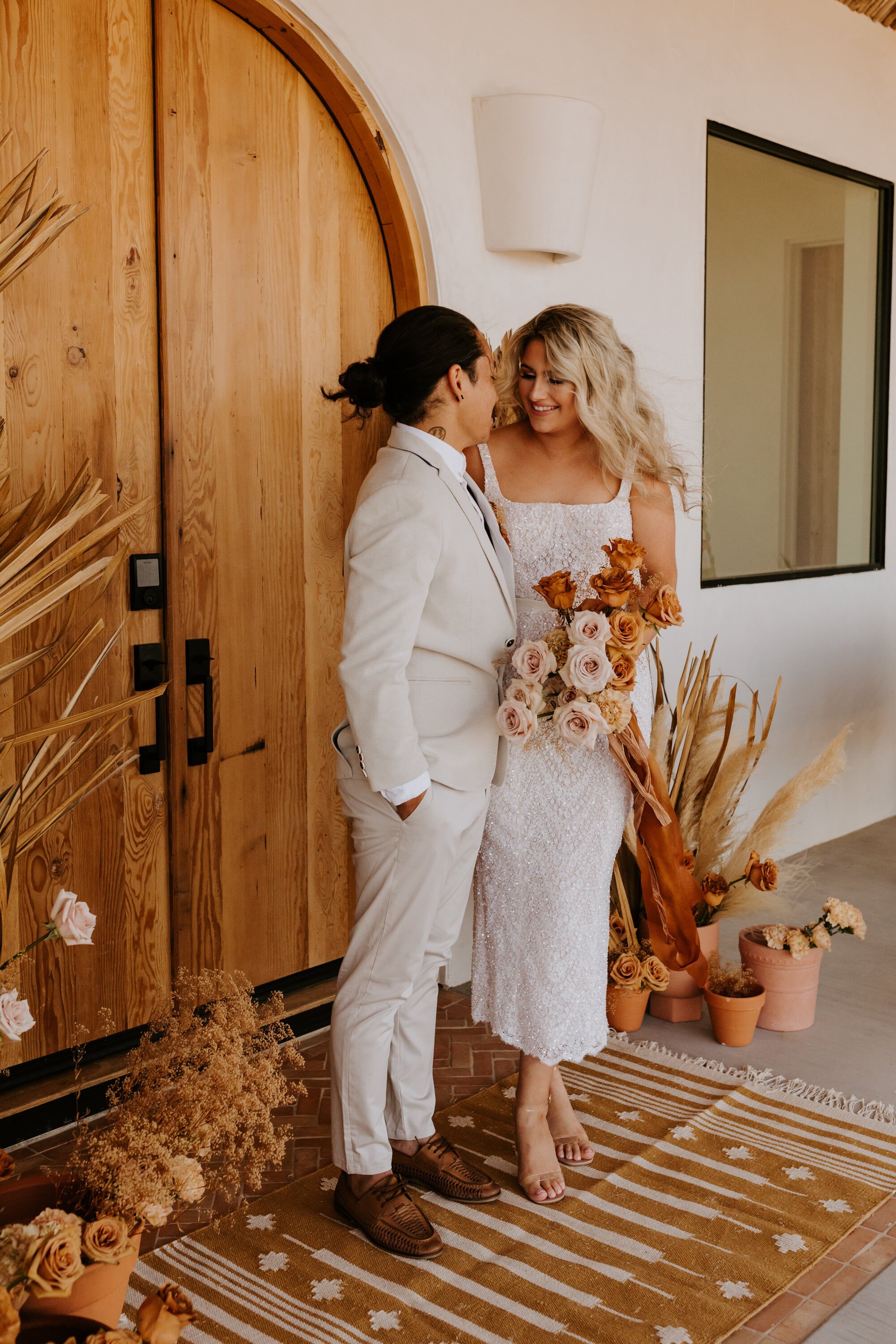 Rust neutral ombre bridal bouquet with rust ribbon | Joshua Tree Elopement | Florals by Cultivated by Faith | Photo by Tida Svy | www.tidasvy.com