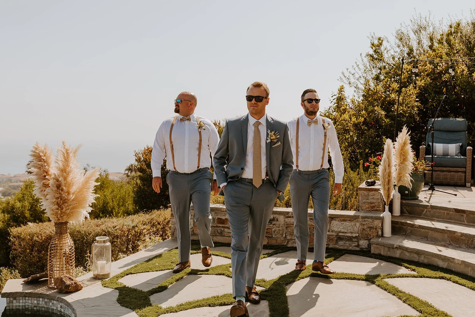 Groomsmen in blue suits, suspenders, and sunglasses, Rancho Palos Verdes boho backyard wedding, Photo by Tida Svy