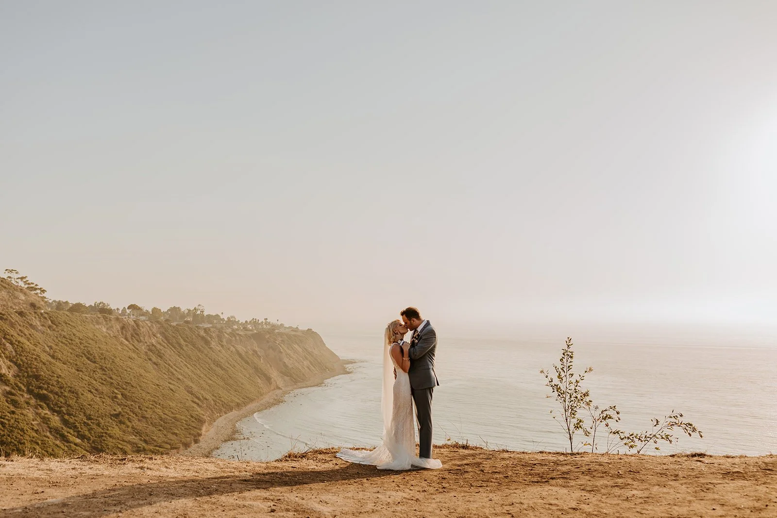 Golden hour bride and groom portrait, Rancho Palos Verdes cliffside, California wedding photography, Photo by Tida Svy