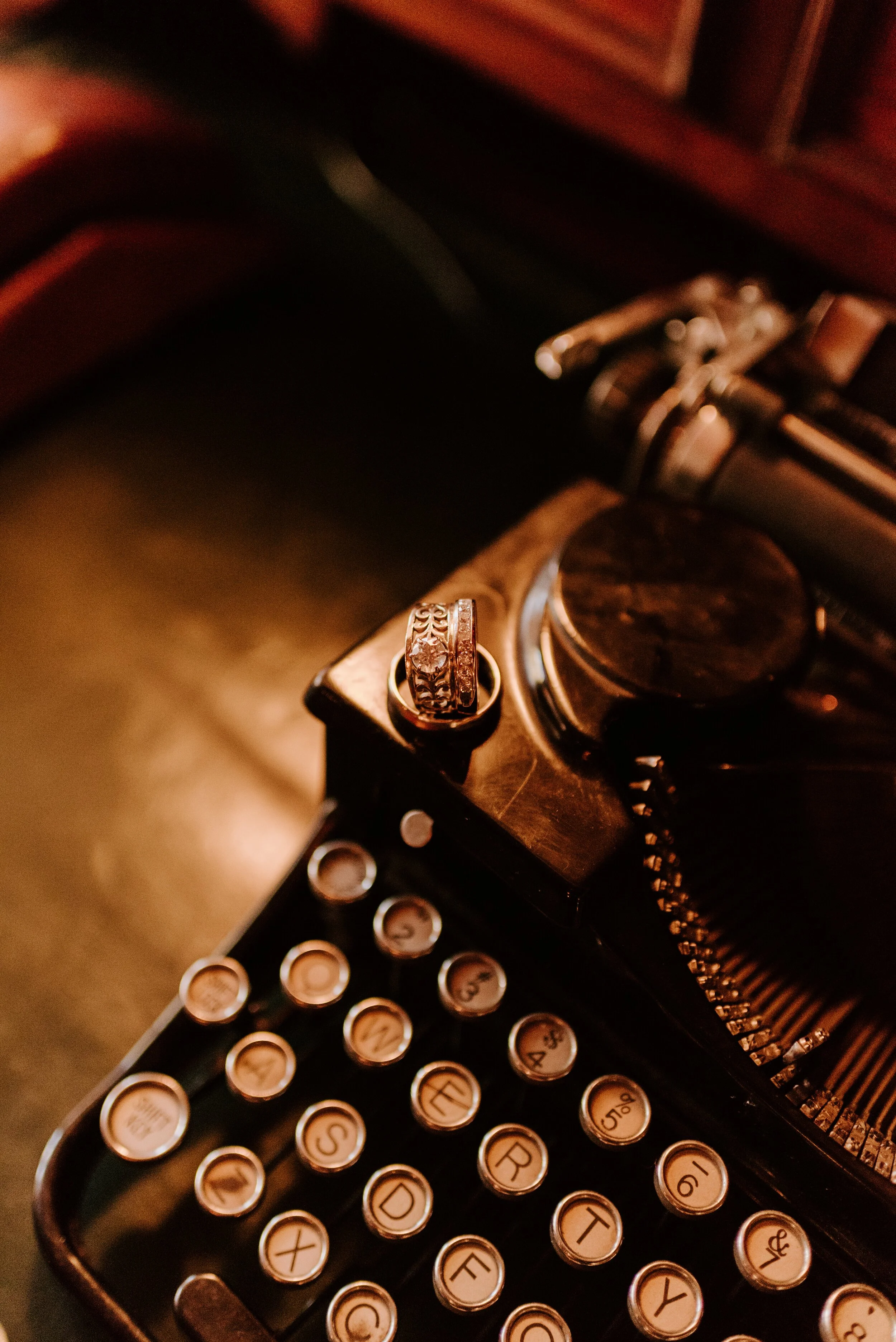 Typewriter and wedding rings detail photo | Newhall Mansion Wedding | Piru, CA | Southern California Wedding Photographer | Photo by Tida Svy | www.tidasvy.com