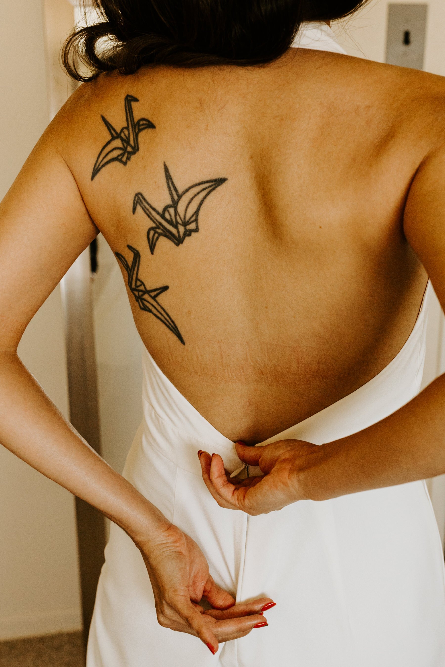 Bride with back tattoos and low back wedding jumsuit | Photo by Tida Svy | www.tidasvy.com