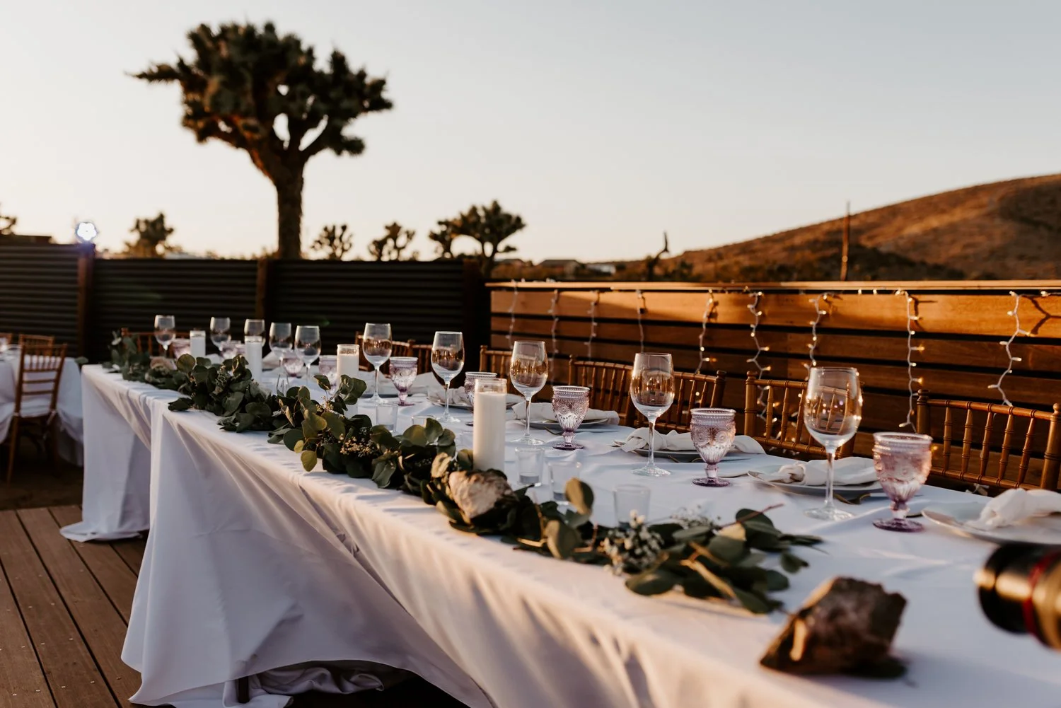 Desert wedding reception simple eucalyptus table setting | Joshua Tree Wedding Photographer | JT Serenity Escape Airbnb Wedding | Tida Svy | www.tidasvy.com