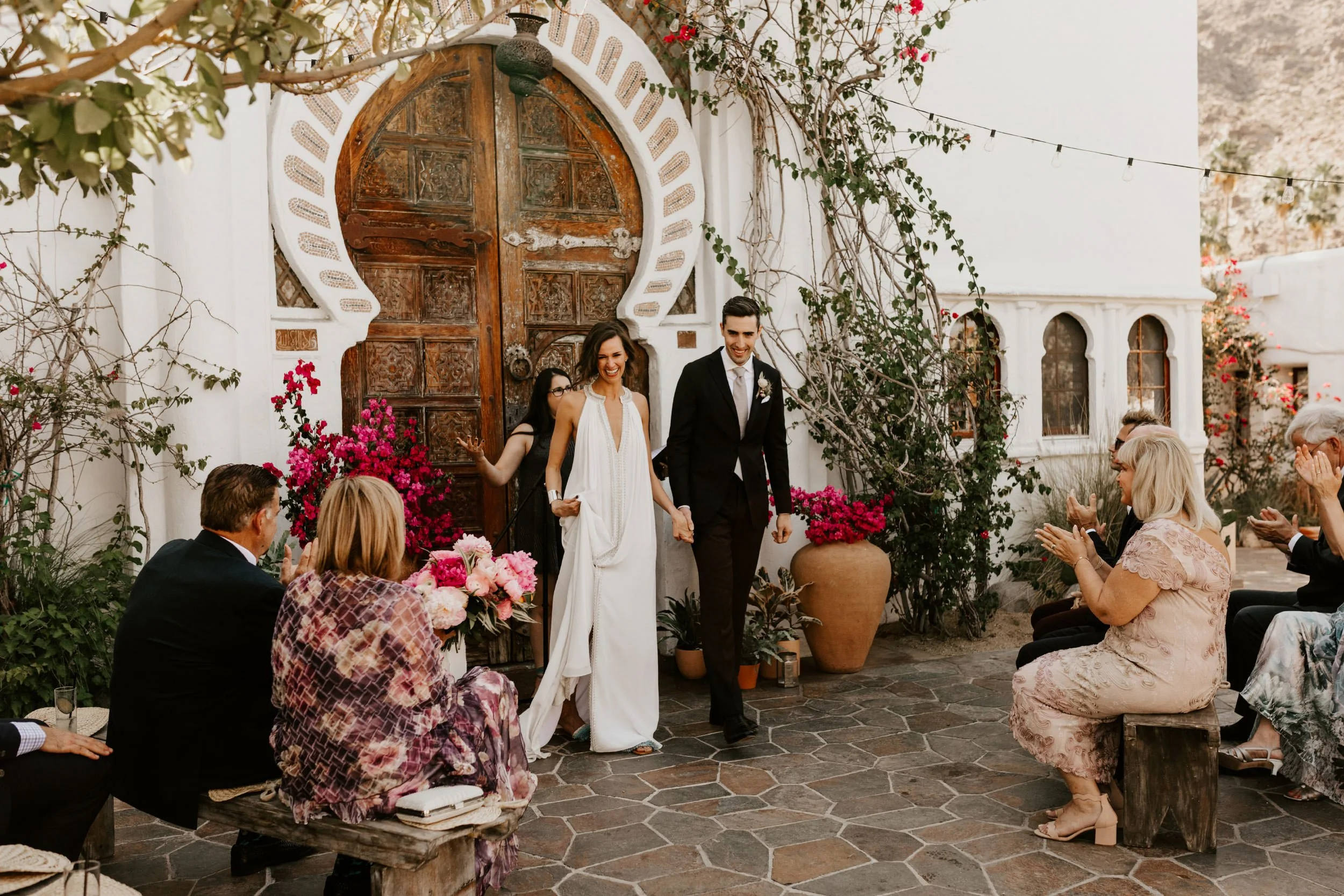 Wedding ceremony in front of Mediterranean arch at Korakia Pensione Palm Springs photographed by Tida Svy