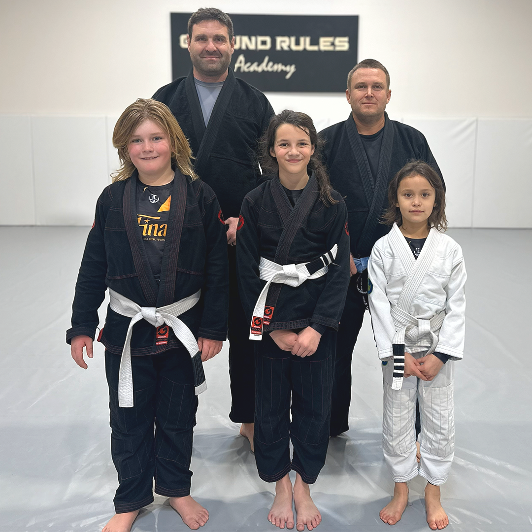 Youth jiu jitsu competitors with coaches