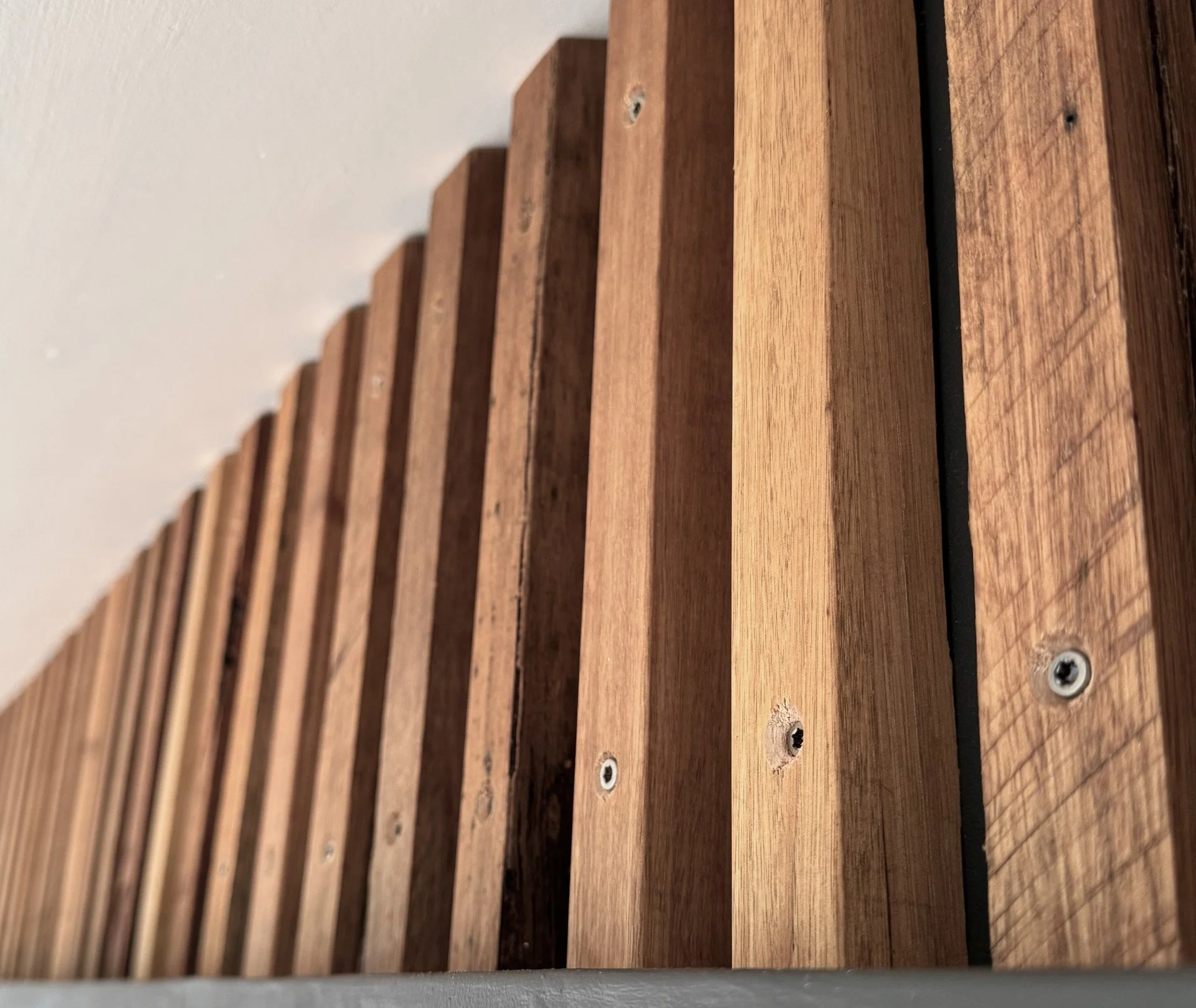 Close-up of a wooden slatted surface with visible screws.