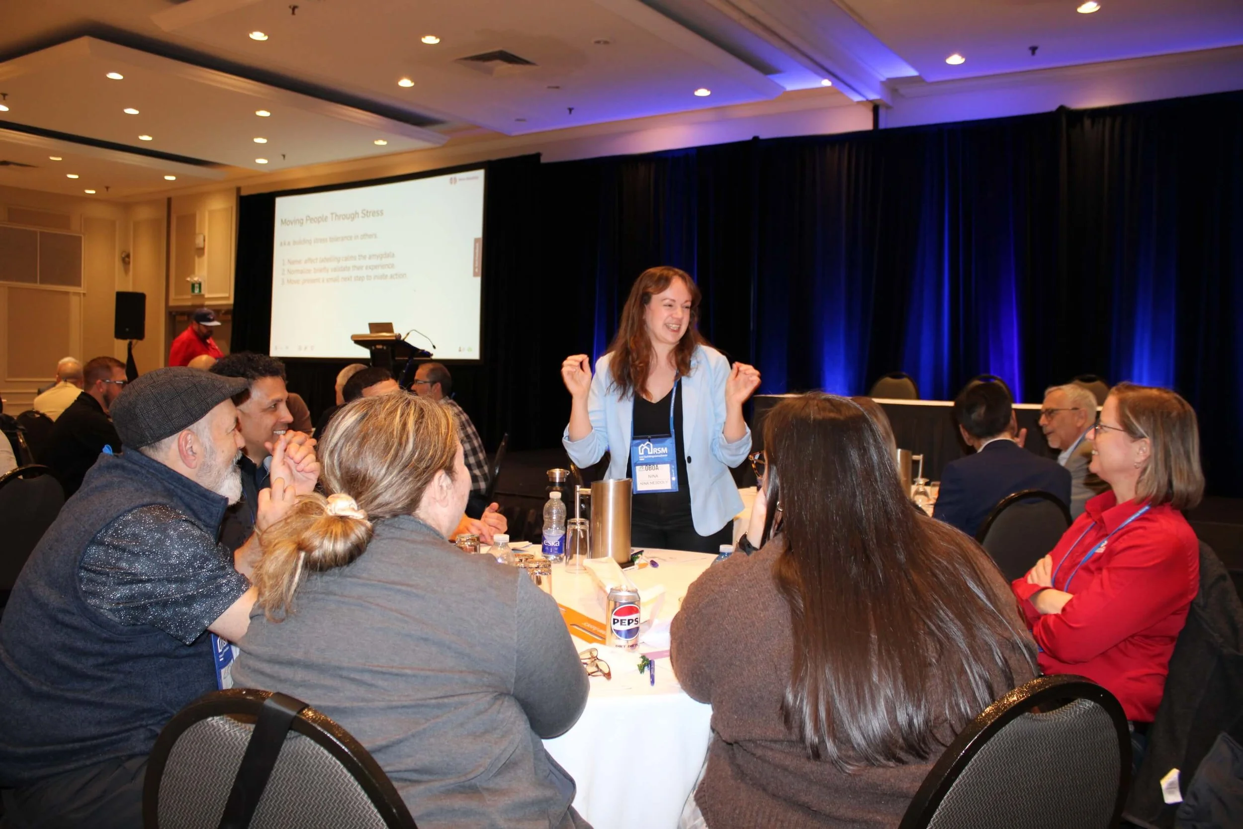 Nina Nesdoly leading interactive workshop session, engaging group discussion on stress, burnout, and work life balance
