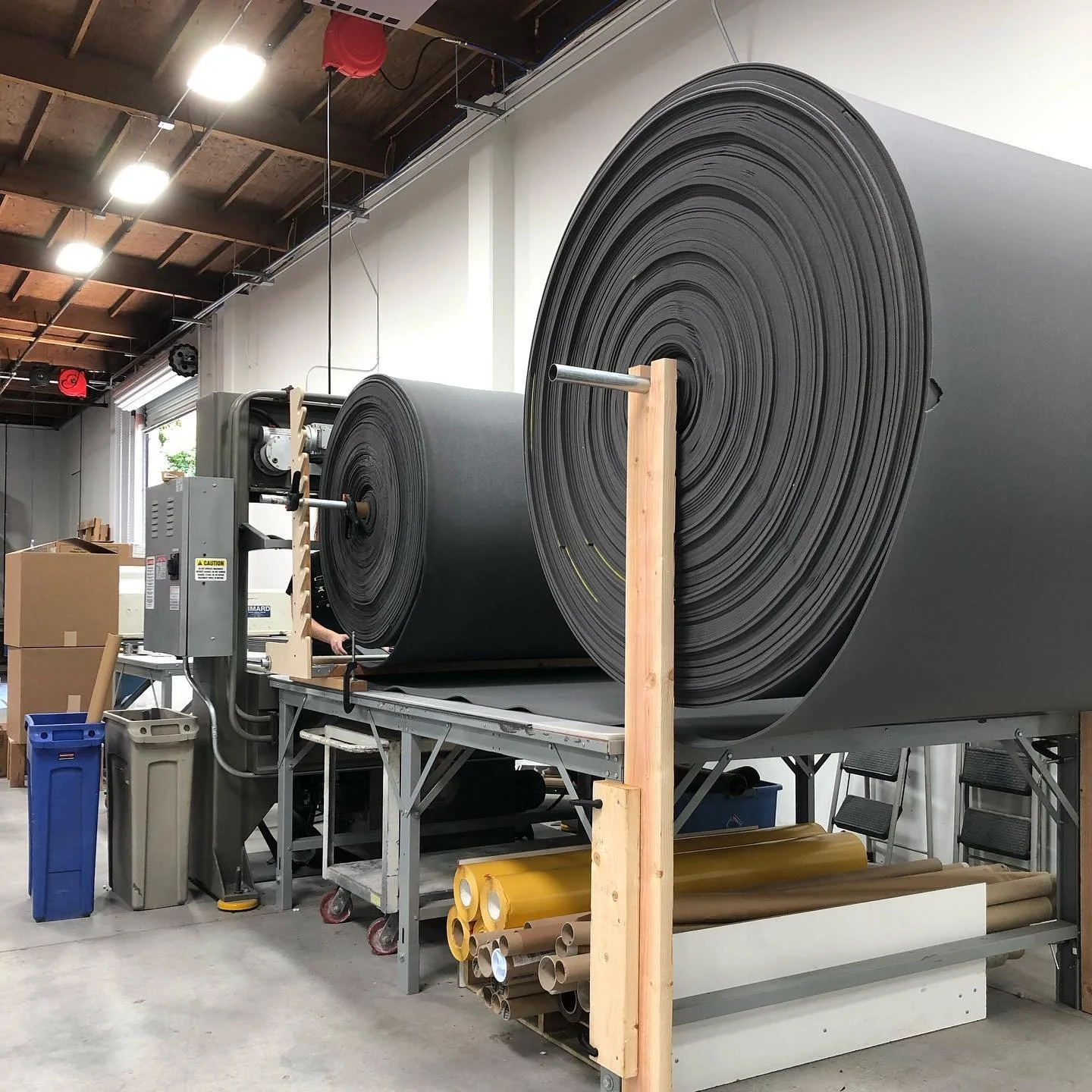 Die cutting giant rolls of foam. #diecuttingmachine #manufacturing #seating