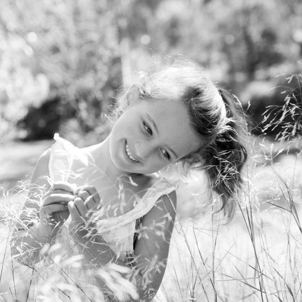 Natural Family Photography Melbourne Portrait of Girl in tall grass in black and white