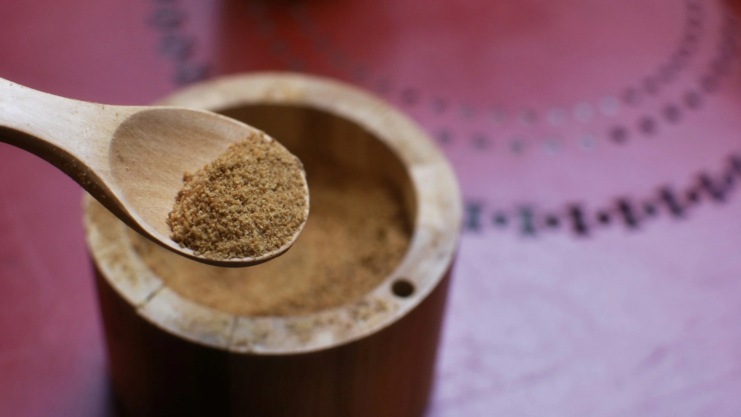 ashwagandha powder in a wooden spoon and bowl