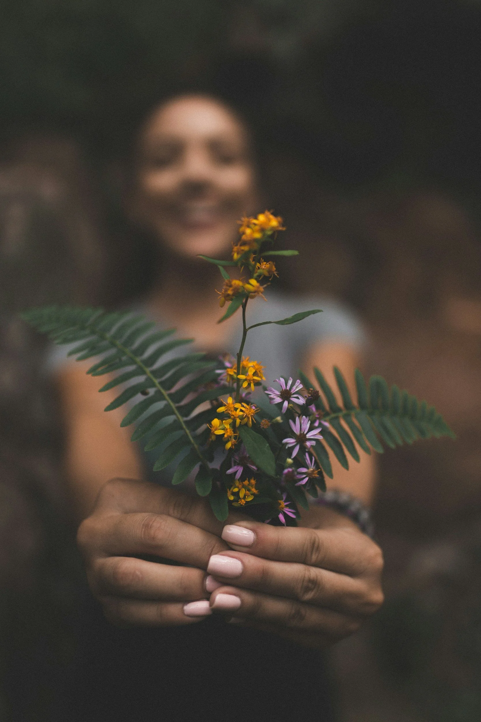 female smiling holding flower bunch