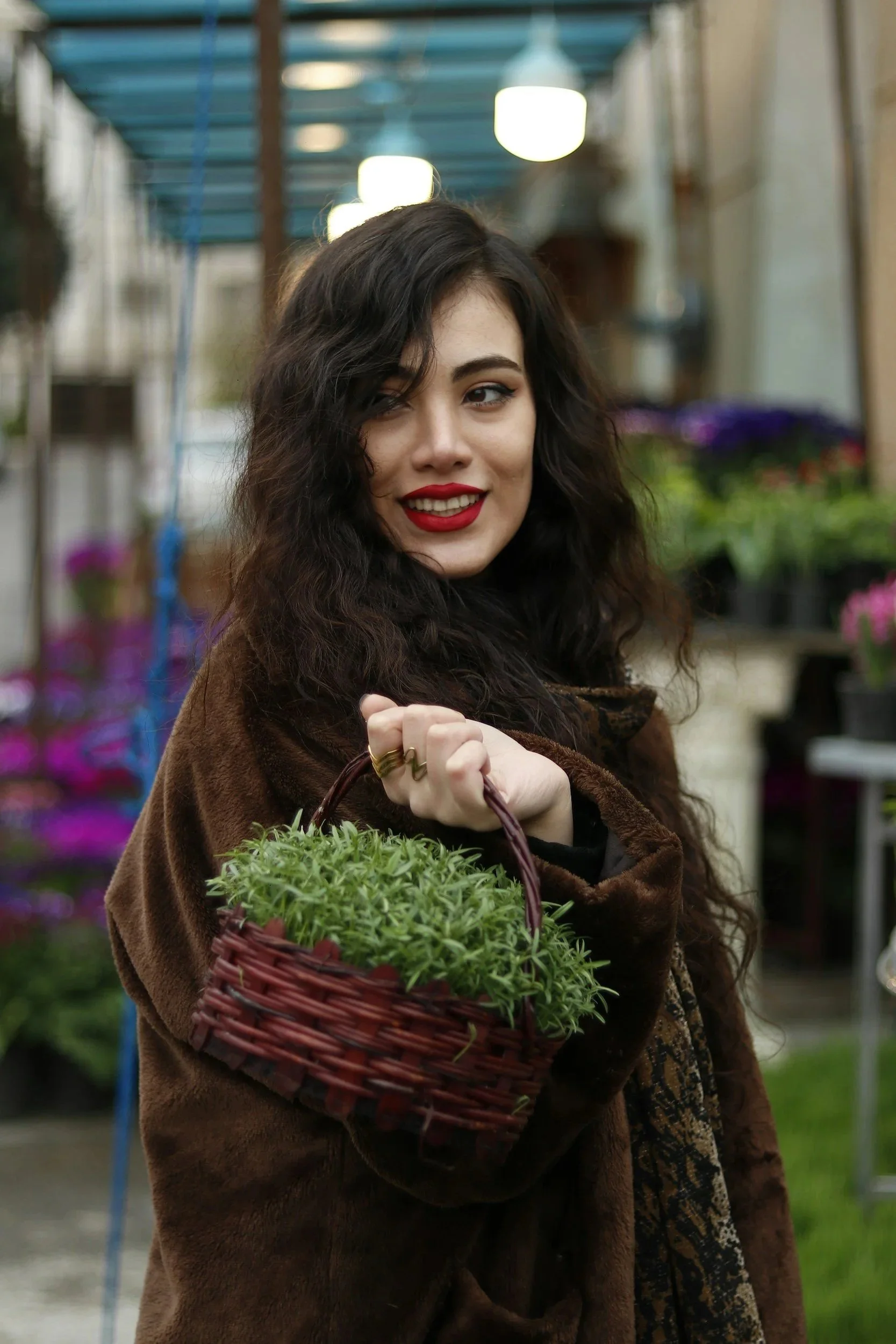Female therapist holding herbs brown basket