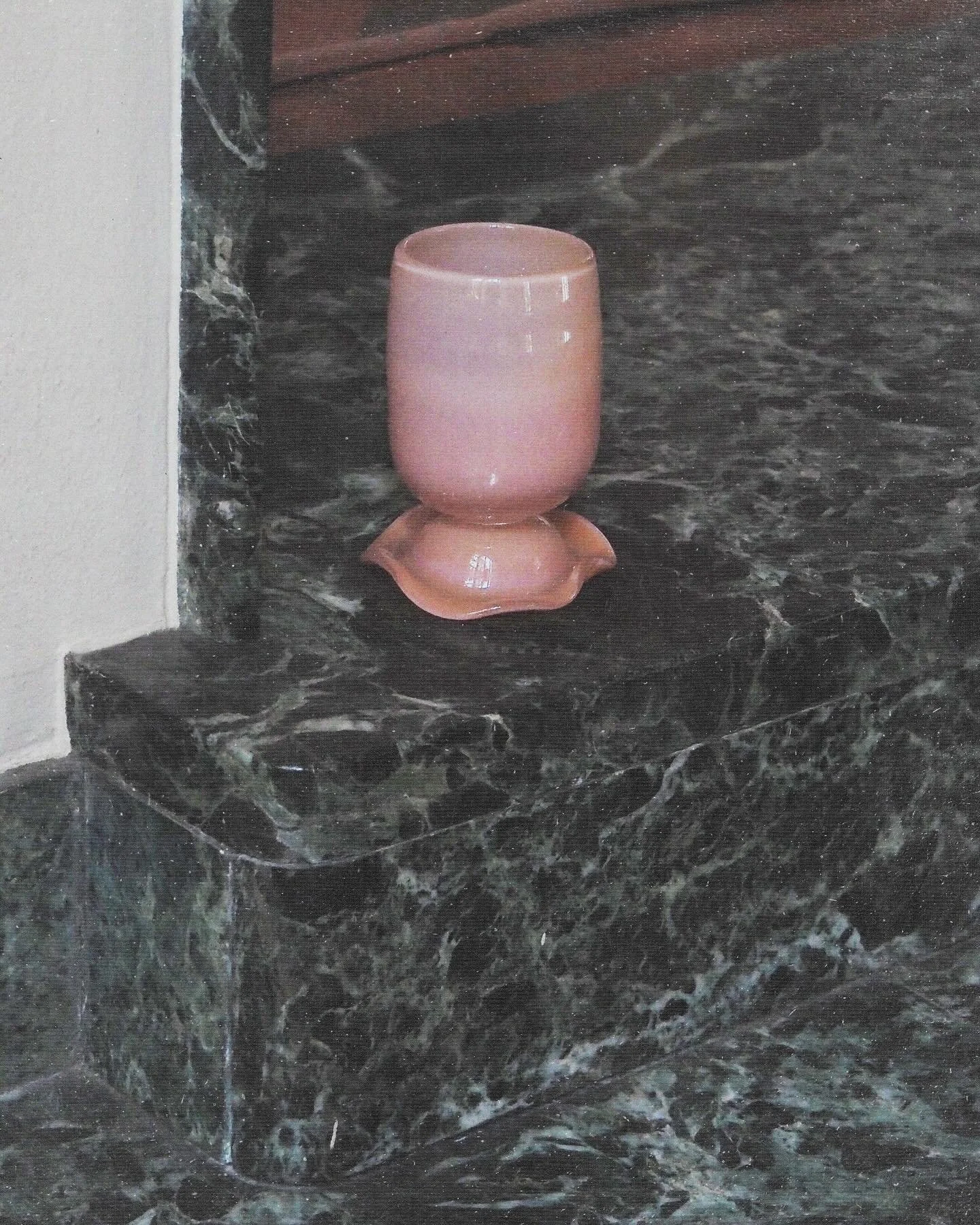 A glass tumbler in apricot hue.