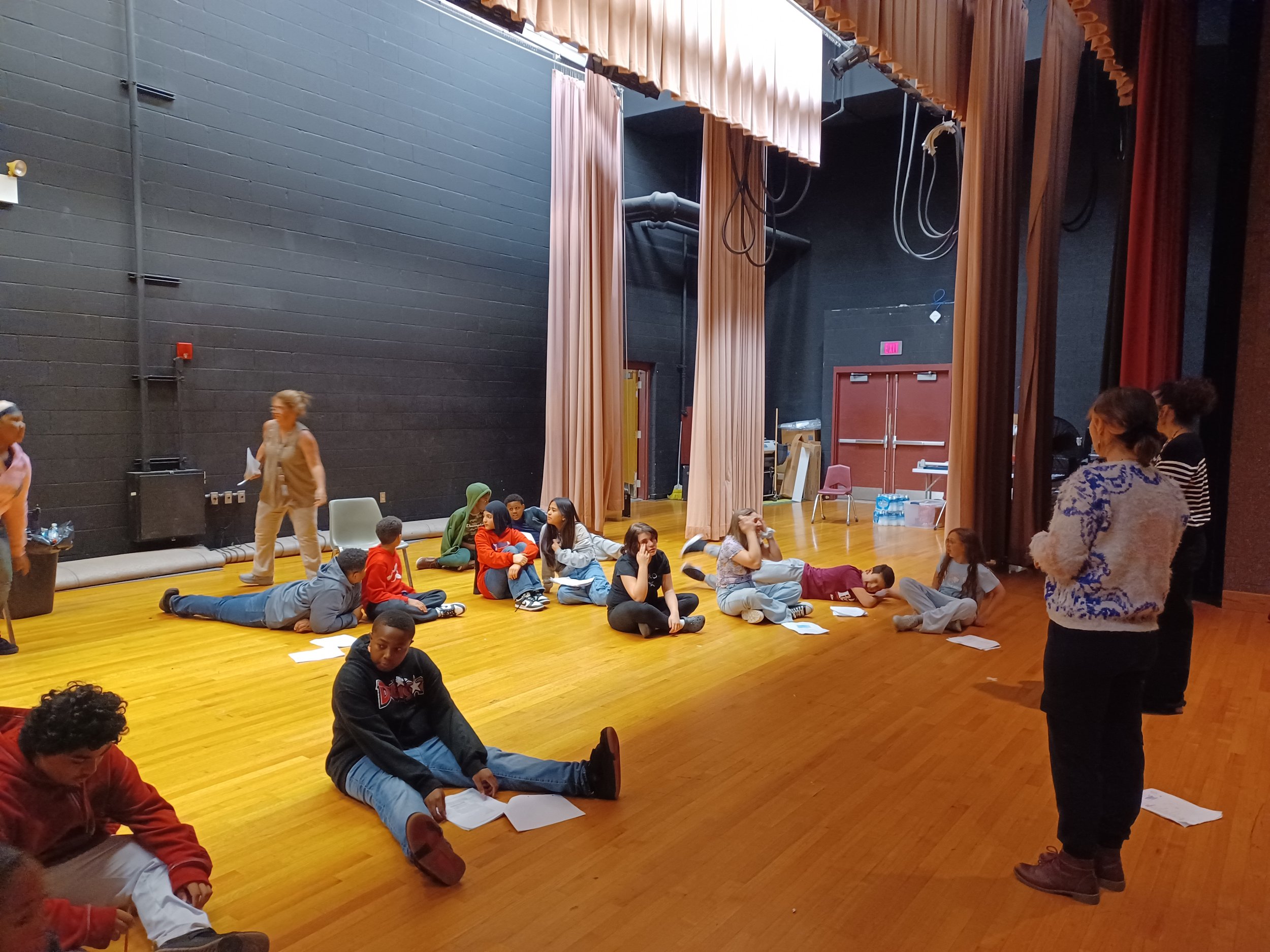 At East Middle School, teaching artist Sara Fisher is working on acting and stagecraft techniques with Drama Club students as they prepare to mount their first production in November.