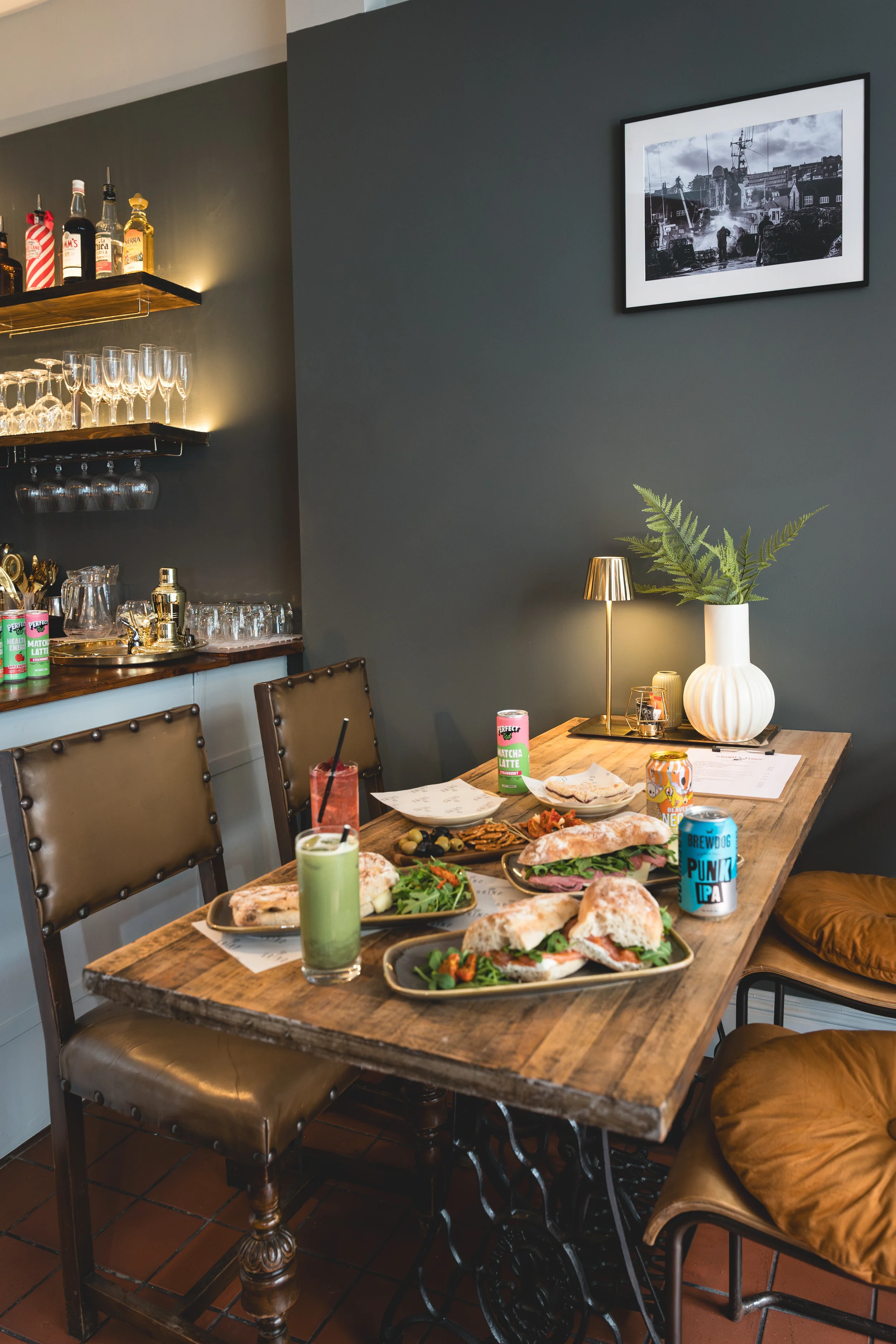 food spread on table and printed image on wall