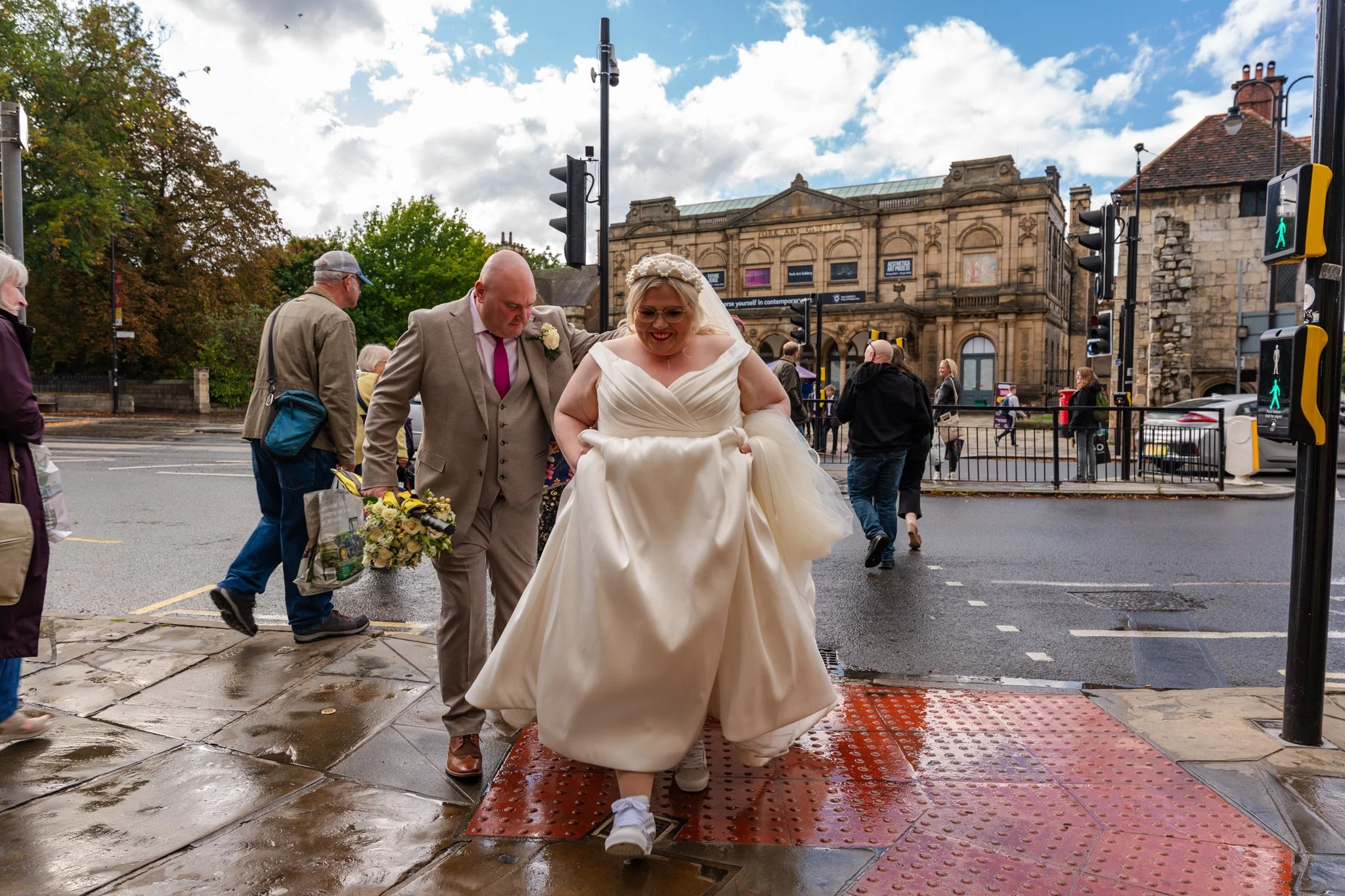 Bride and Groom dodging the puddles in York