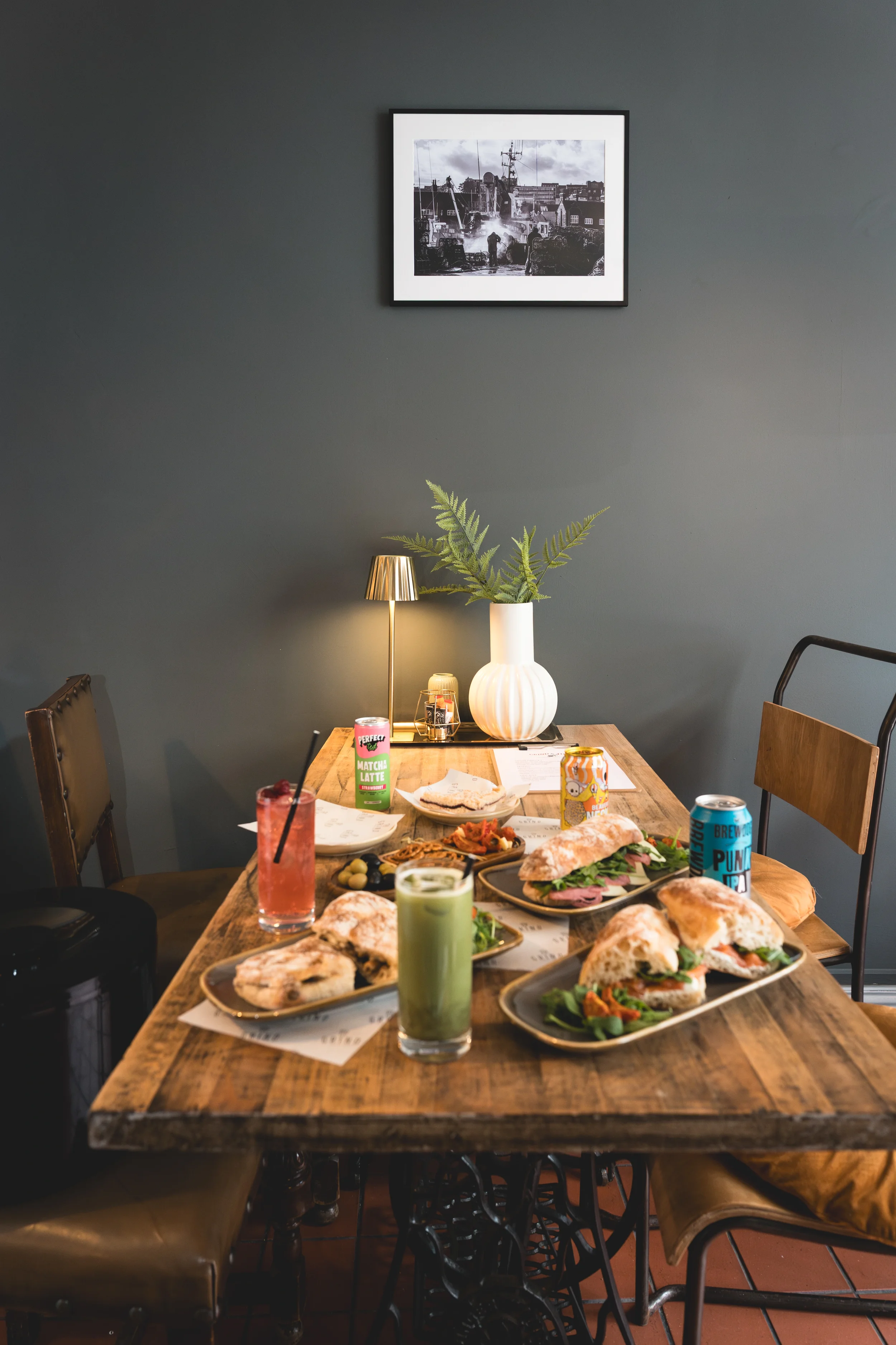 food spread on table and printed image on wall