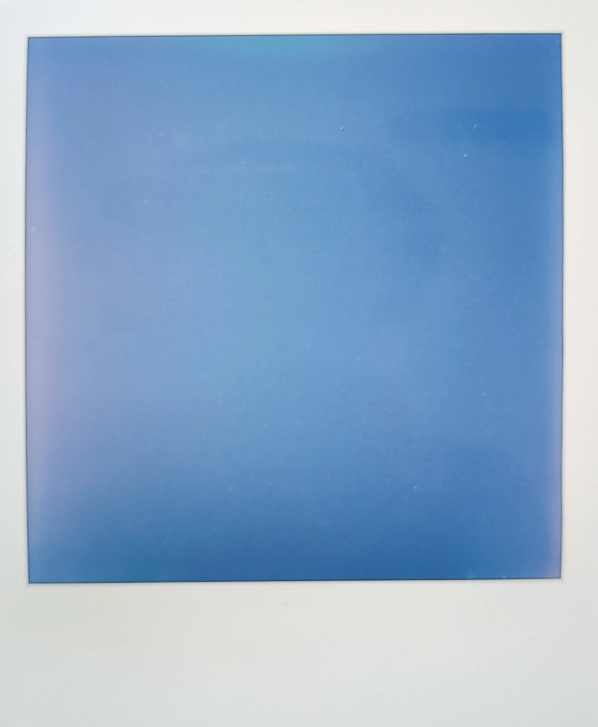 polaroid photo of a clear blue sky