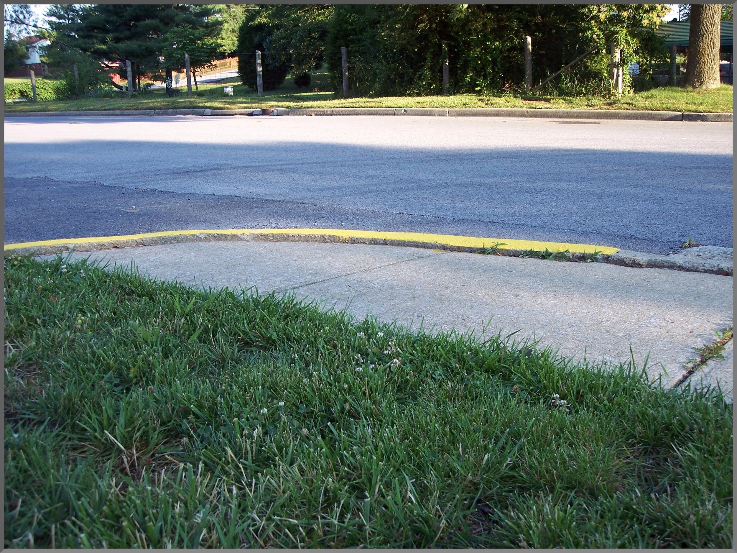 A curb with a raised edge, creating a tripping hazard