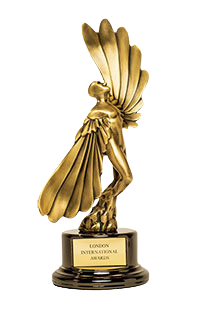 Gold trophy with a figure of a person with wings, mounted on a black base with an inscription reading 'London International Air Awards'.