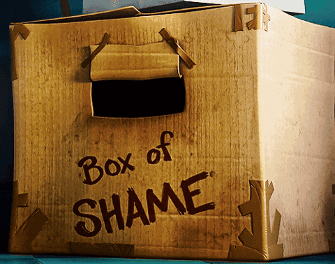 Wooden box labeled 'Box of SHAME' with a handle on top.