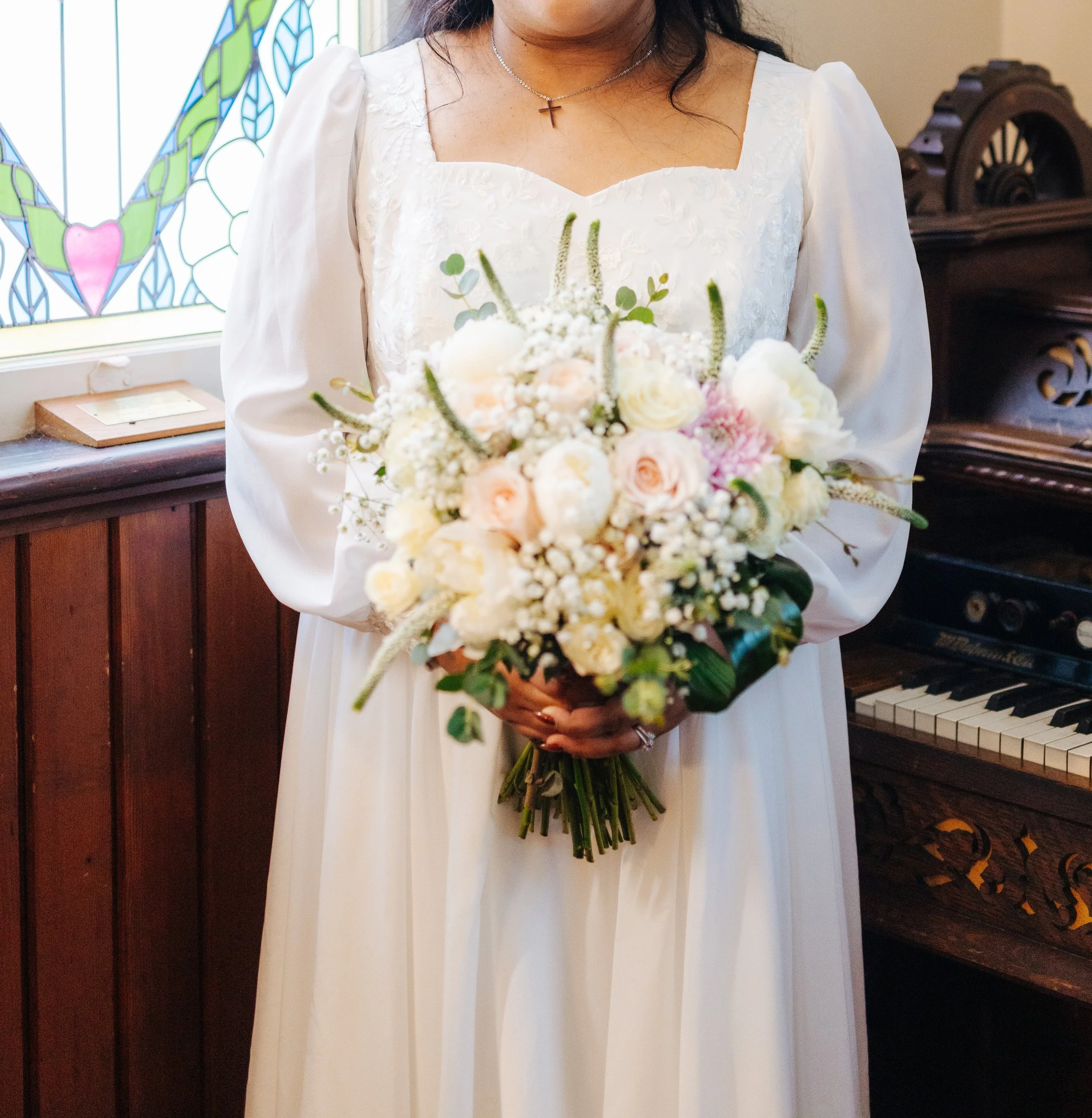 Ona Events bride holding a bouquet of pink and white flowers.