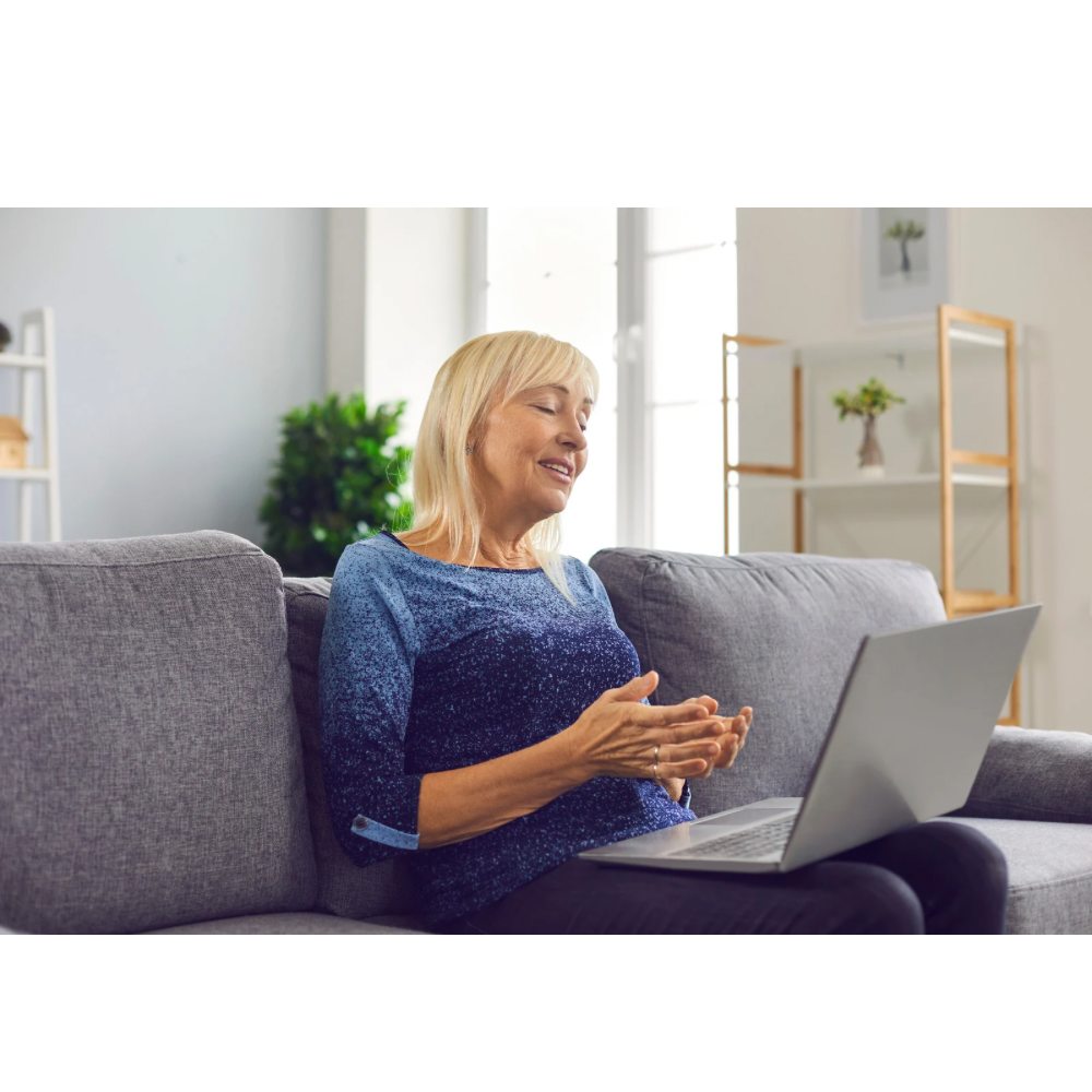 Woman participating in virtual physiotherapy appointment from home